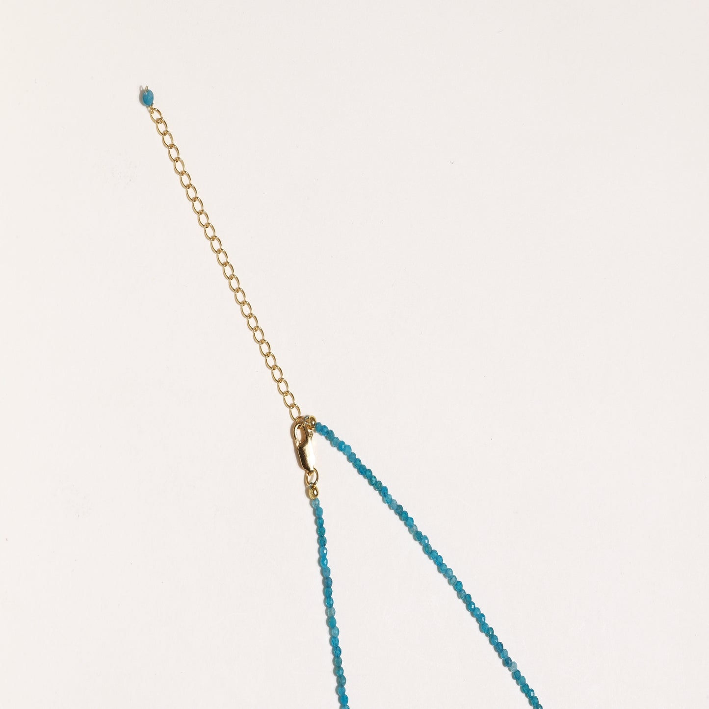 Delicate necklace featuring small turquoise apatite beads with a central freshwater pearl on sterling silver chain