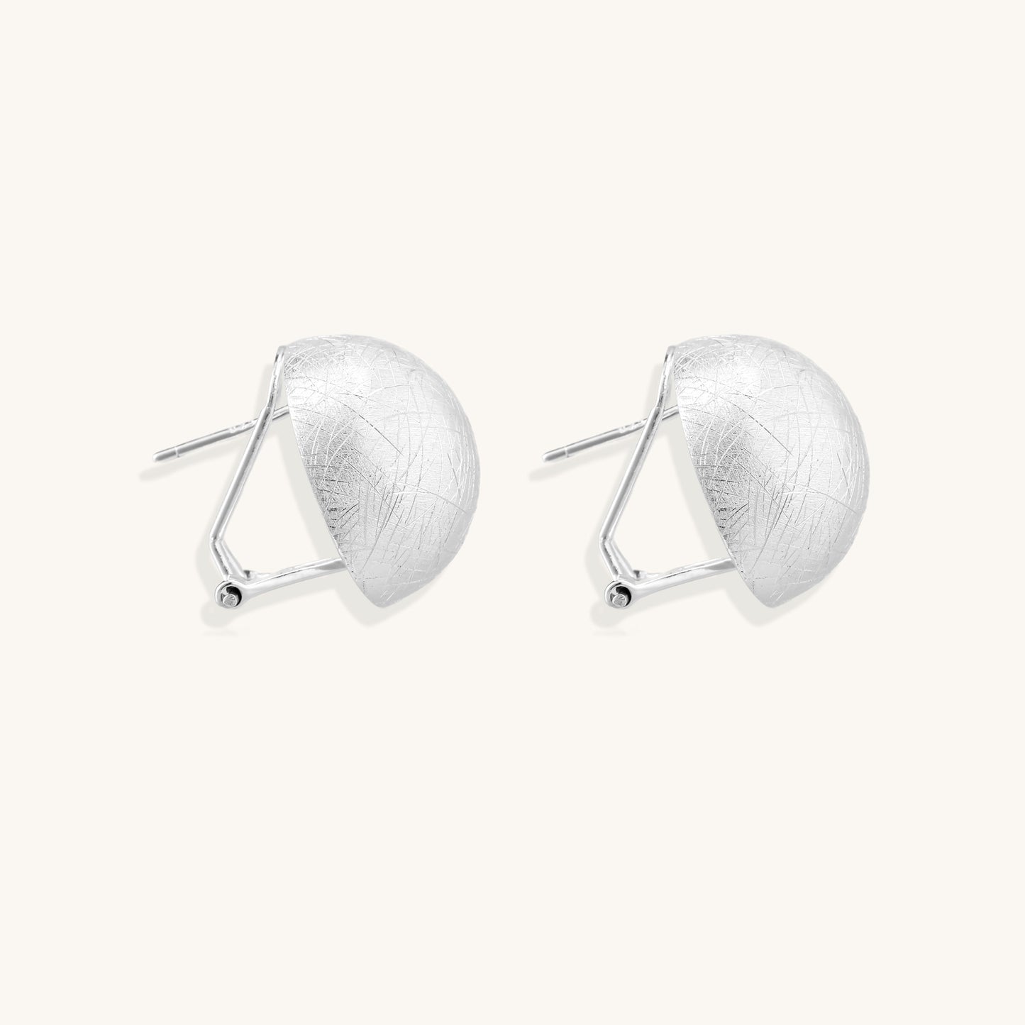 Brushed sterling silver dome-shaped stud earrings with textured surface and secure lever-back closure on white background.