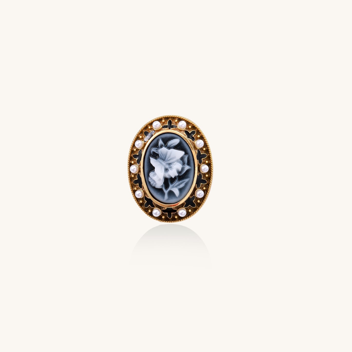 Oval cameo ring with blue-grey floral design surrounded by white shell pearls in gold-plated brass setting