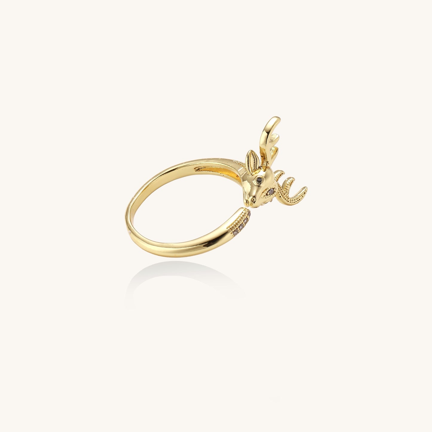 Gold-plated brass deer antler ring with cubic zirconia stones featuring detailed stag head design on white background.
