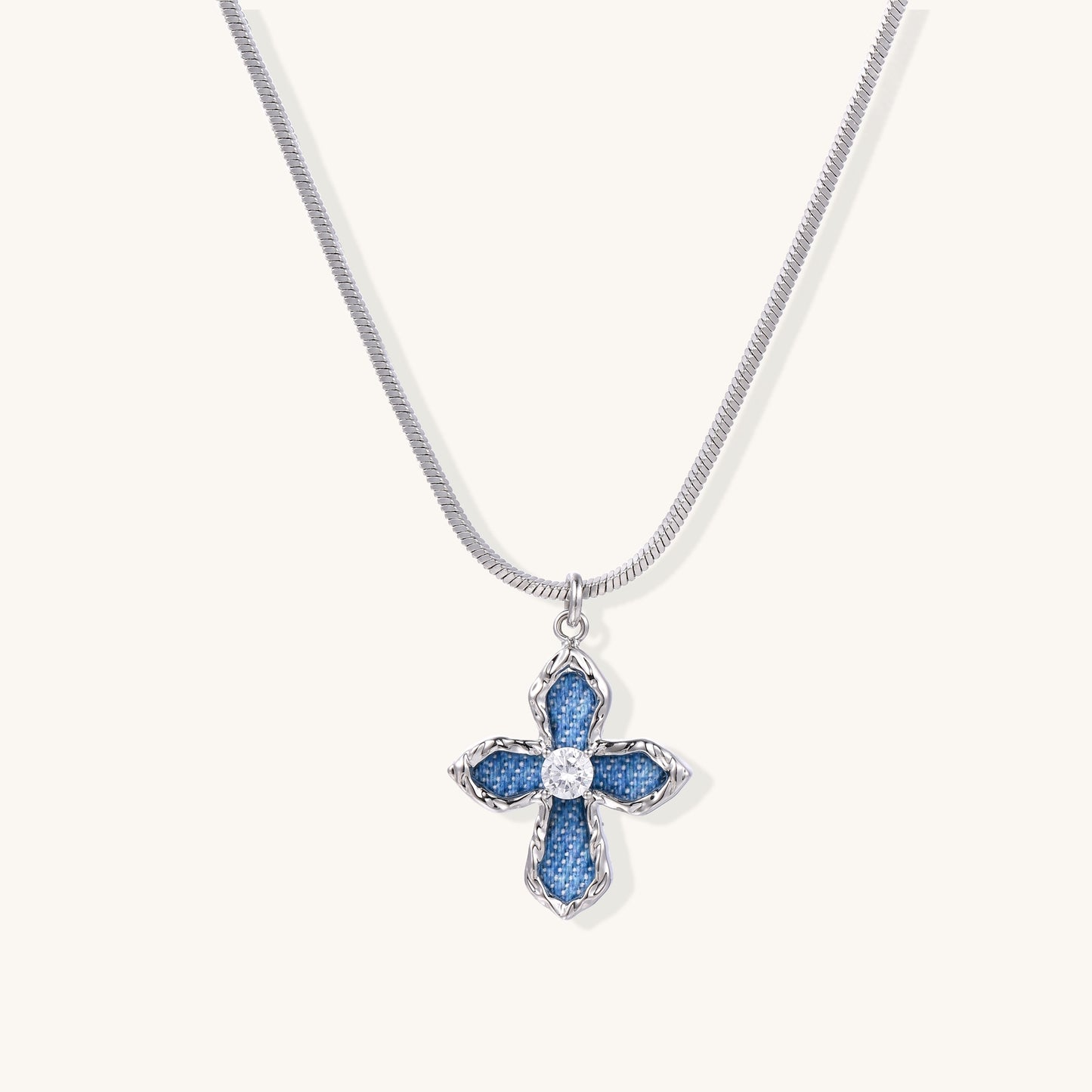 Gold-plated cross pendant with blue denim fabric insets and central zirconia stone on adjustable snake chain