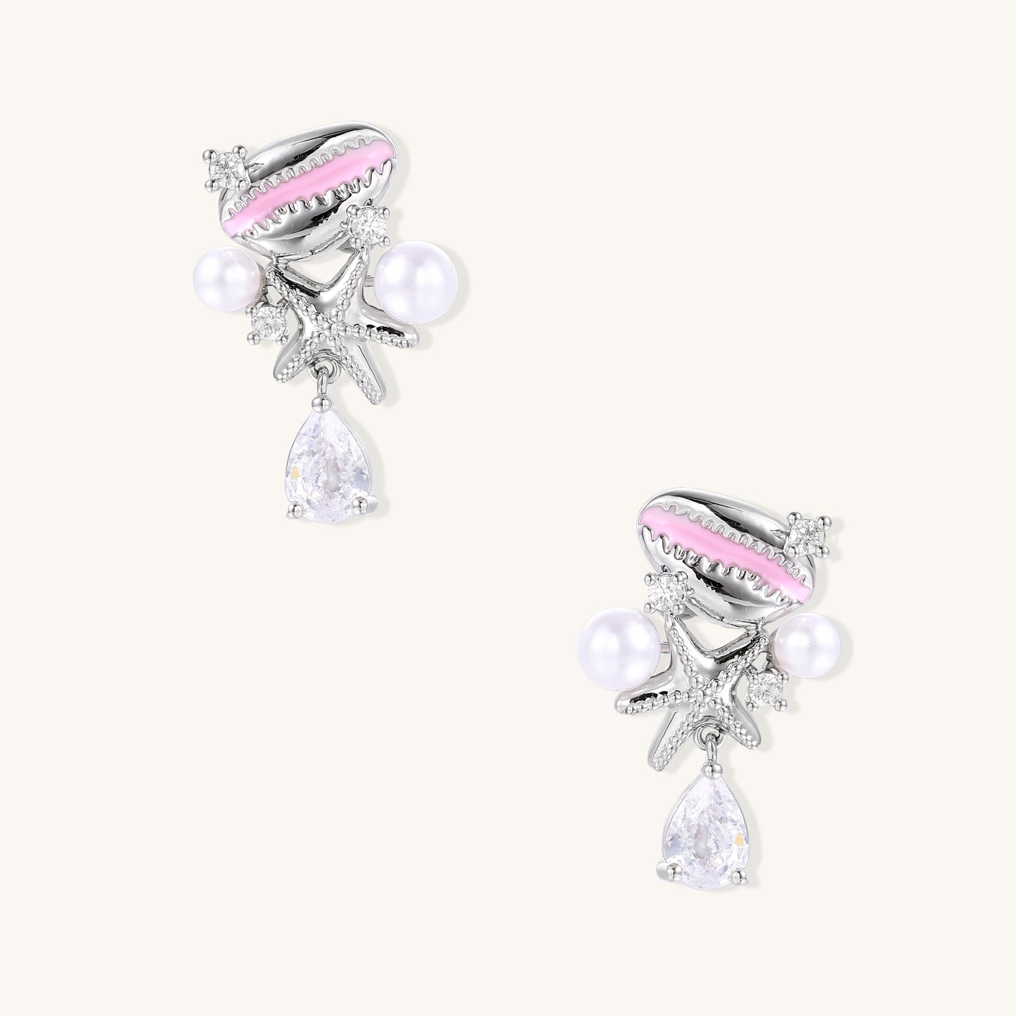 Gold-plated dangle earrings with enamel shell charms, white pearls, starfish accents, and crystal drops on white background.