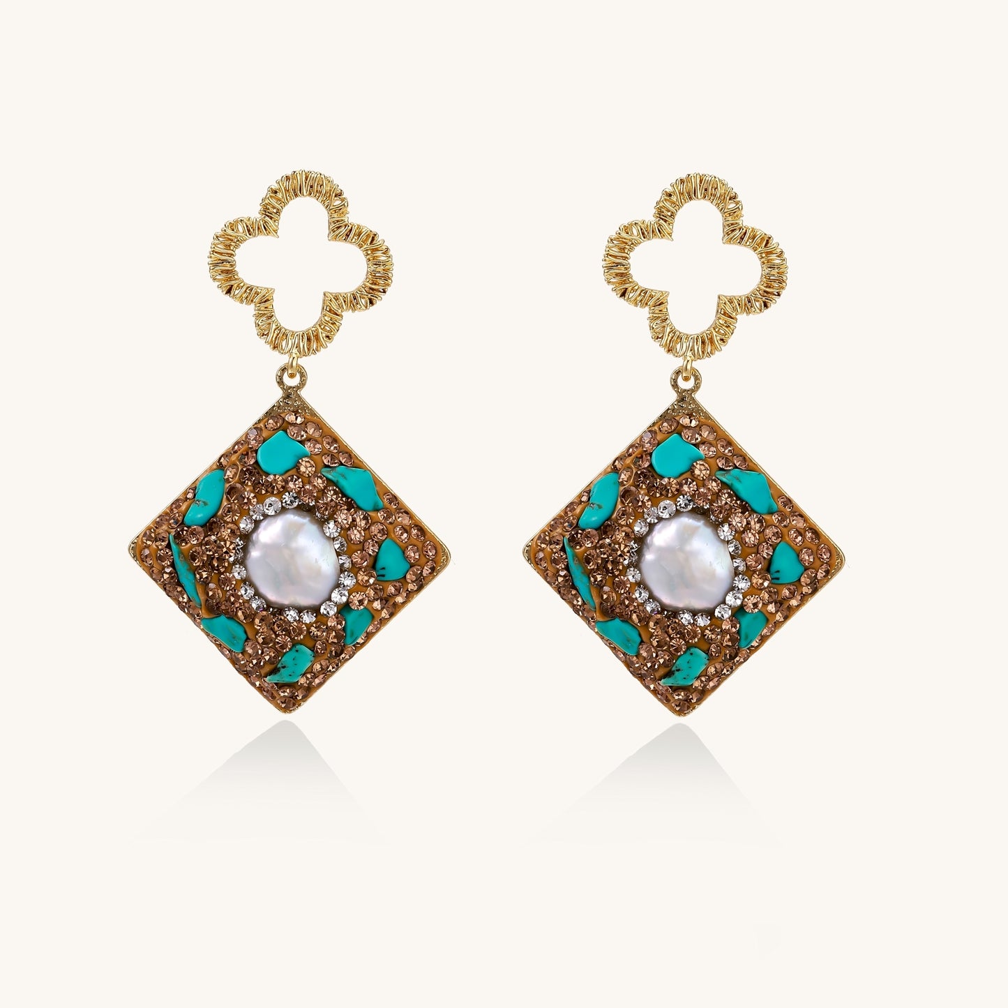 Gold quatrefoil stud earrings with ornate square pendants featuring turquoise stones and freshwater pearls