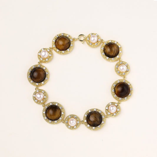 Ornate gold-plated bracelet with alternating brown tiger's eye stones and white freshwater pearls in crystal-accented settings