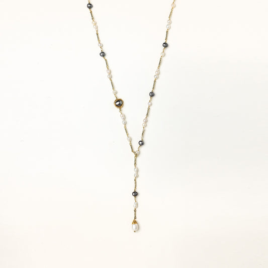 Long gold-plated necklace with alternating white and gray freshwater pearls spaced along delicate chain segments