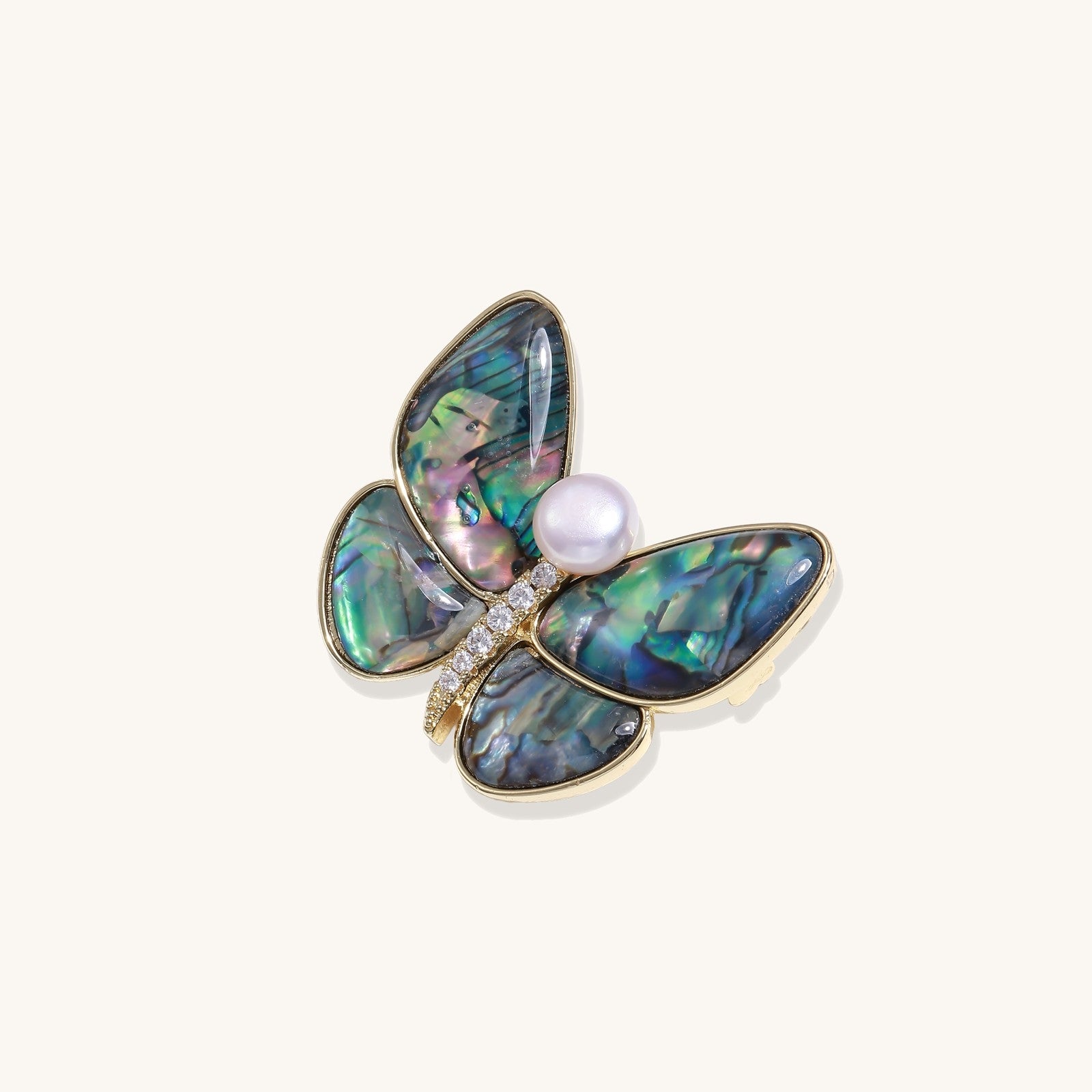 Iridescent abalone shell butterfly pin with central pearl and gold setting, showing rainbow color reflections