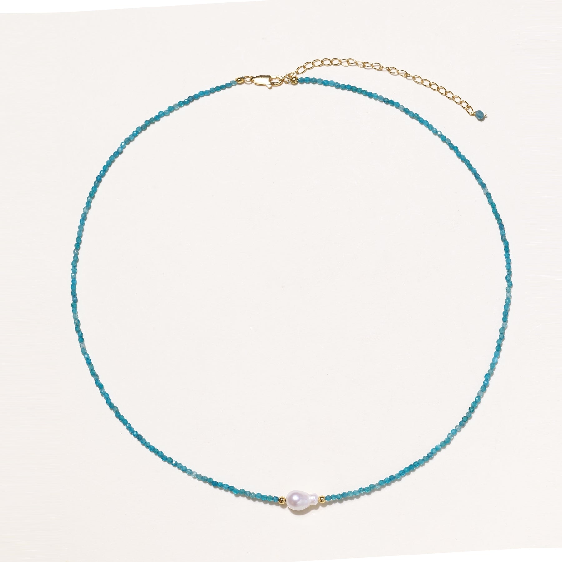 Delicate necklace featuring small turquoise apatite beads with a central freshwater pearl on sterling silver chain