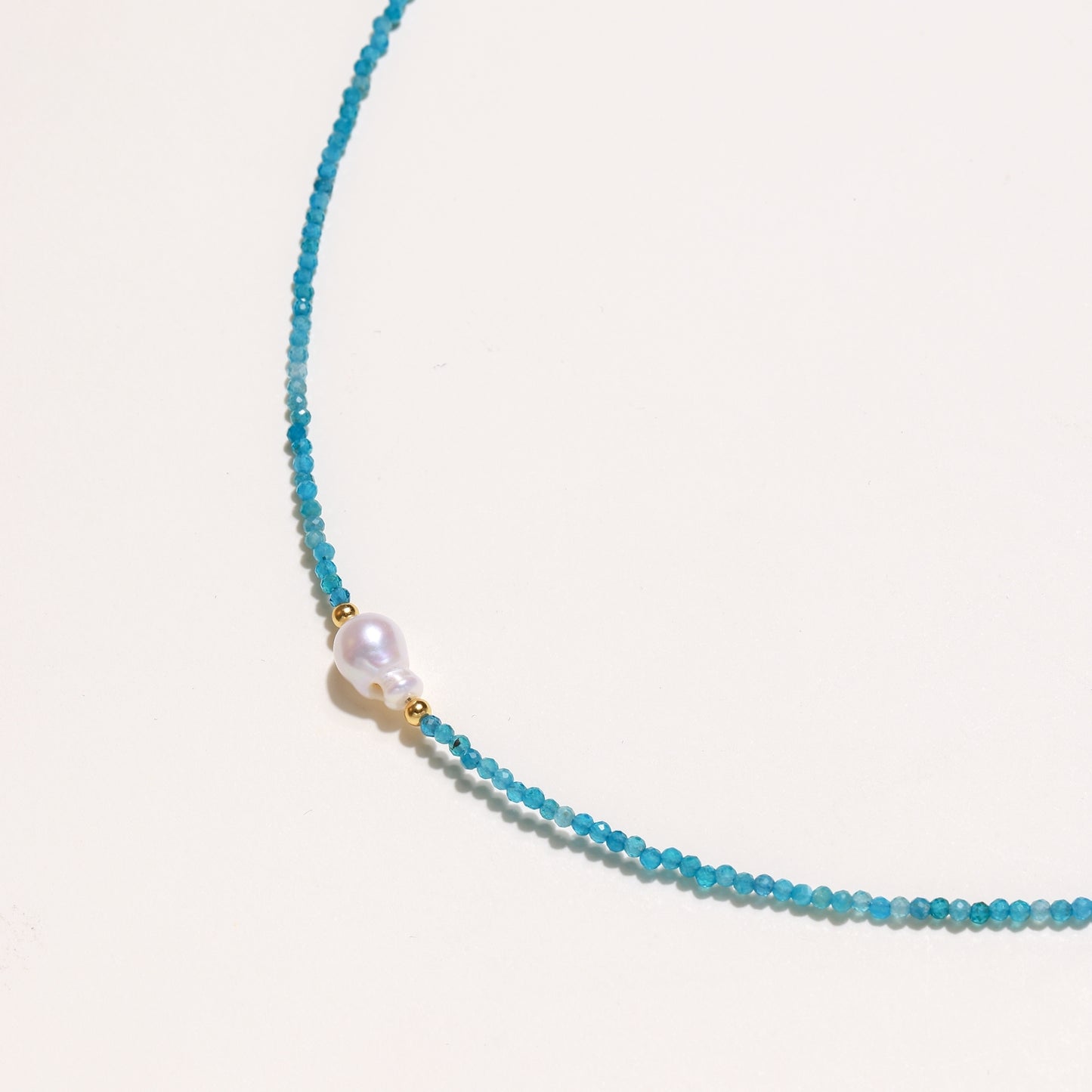 Delicate necklace featuring small turquoise apatite beads with a central freshwater pearl on sterling silver chain