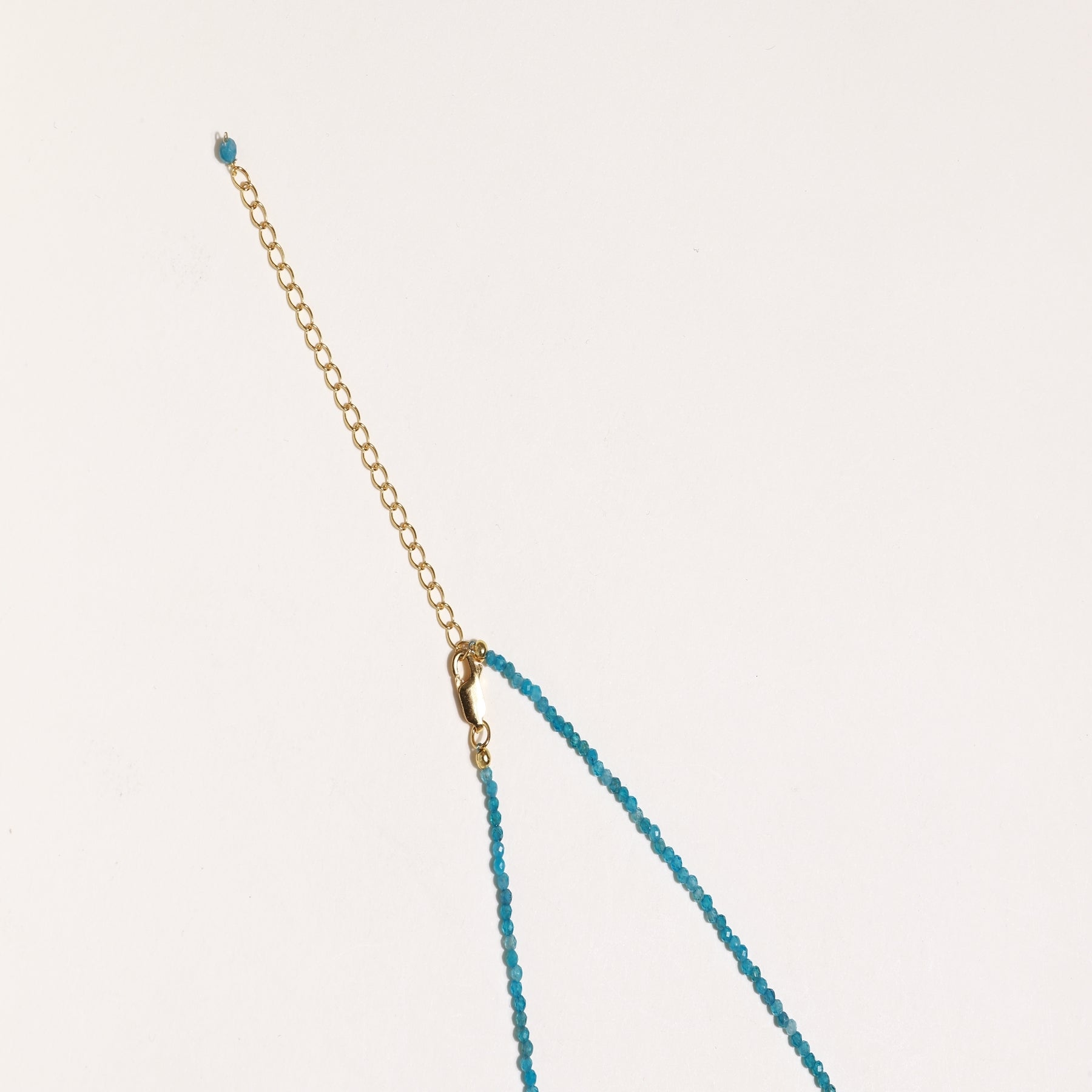 Delicate necklace featuring small turquoise apatite beads with a central freshwater pearl on sterling silver chain