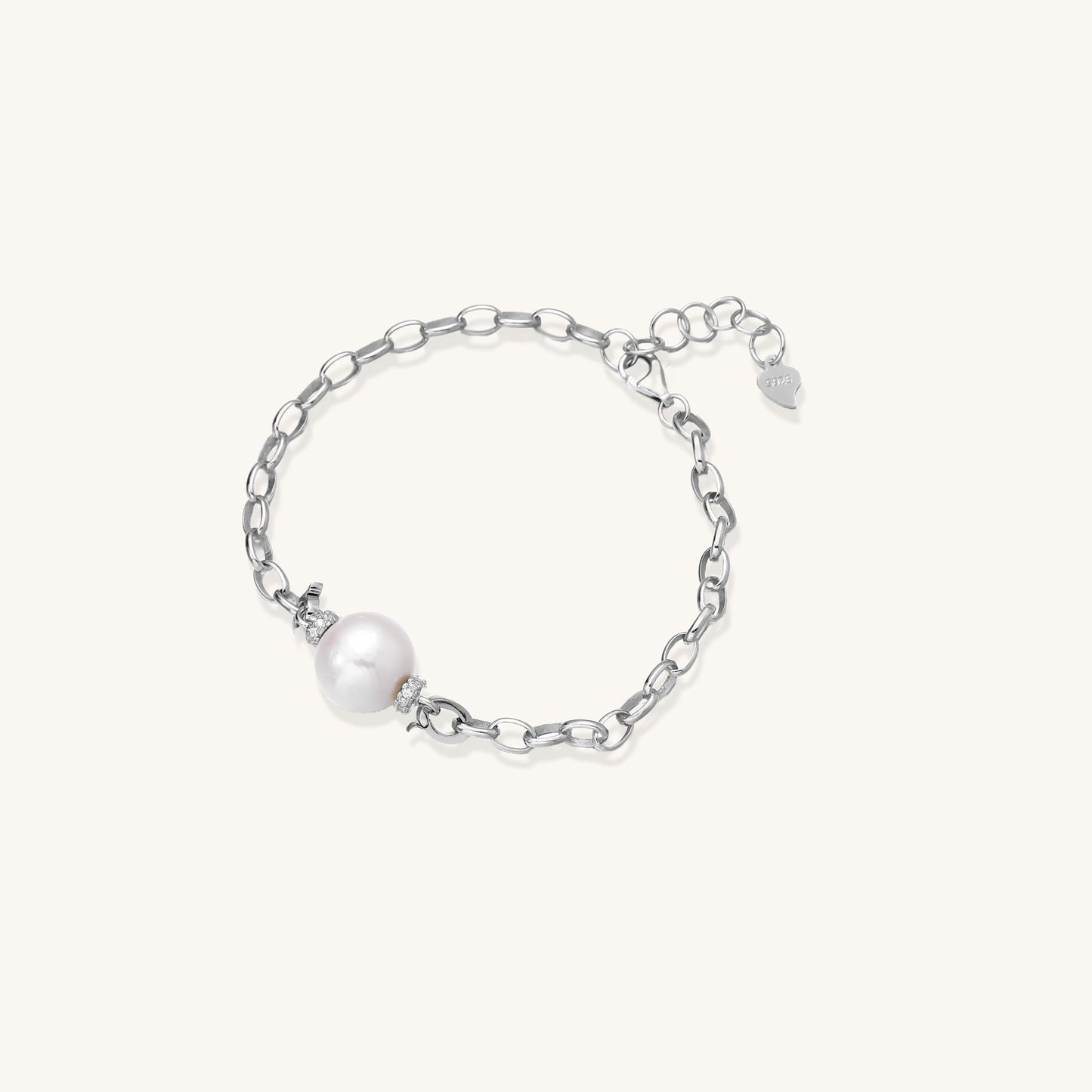 Dainty sterling silver chain bracelet with round freshwater pearl and crystal accents on white background.