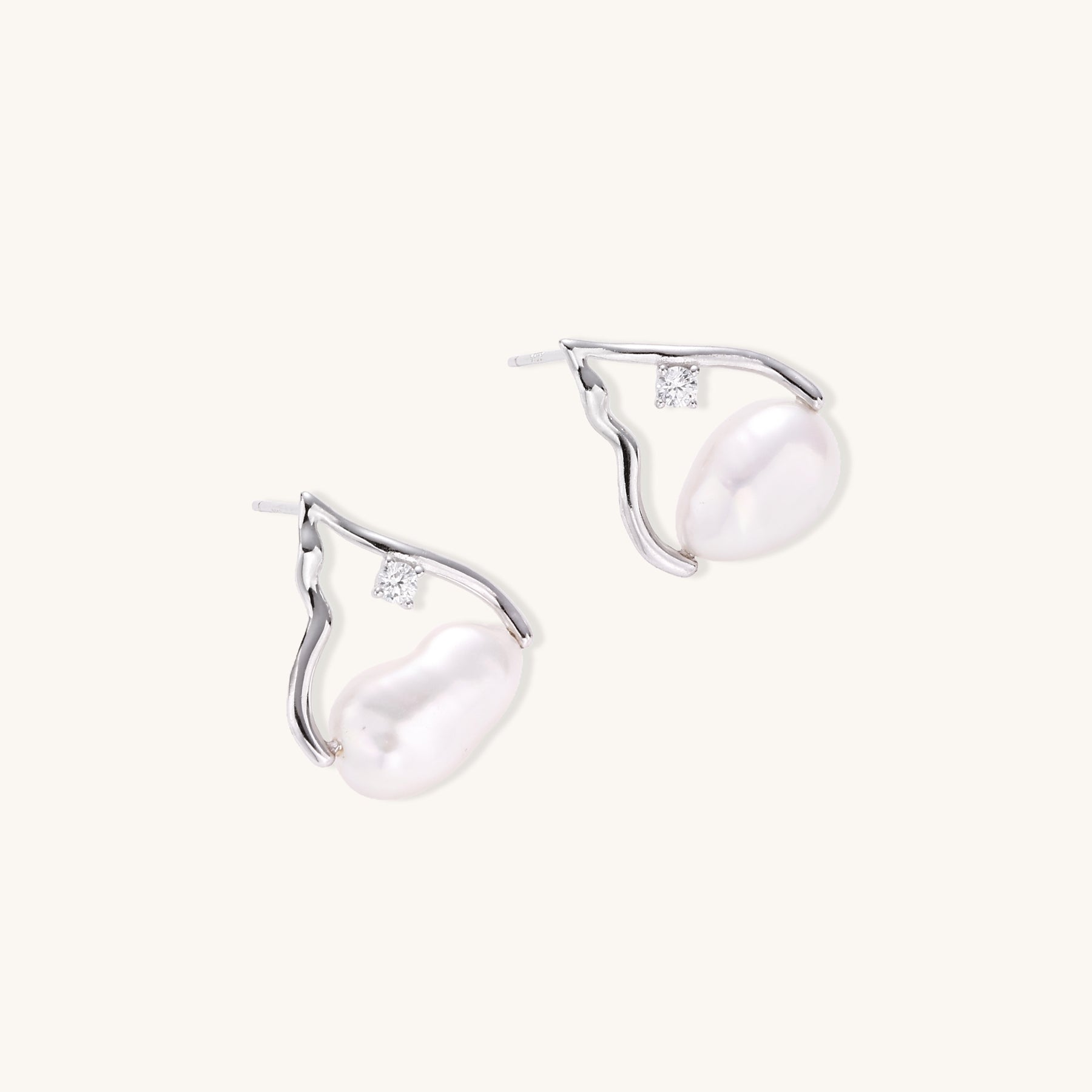 Sterling silver teardrop-shaped stud earrings with white freshwater pearls nestled in elegant flame-like frames