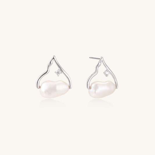 Sterling silver teardrop-shaped stud earrings with white freshwater pearls nestled in elegant flame-like frames