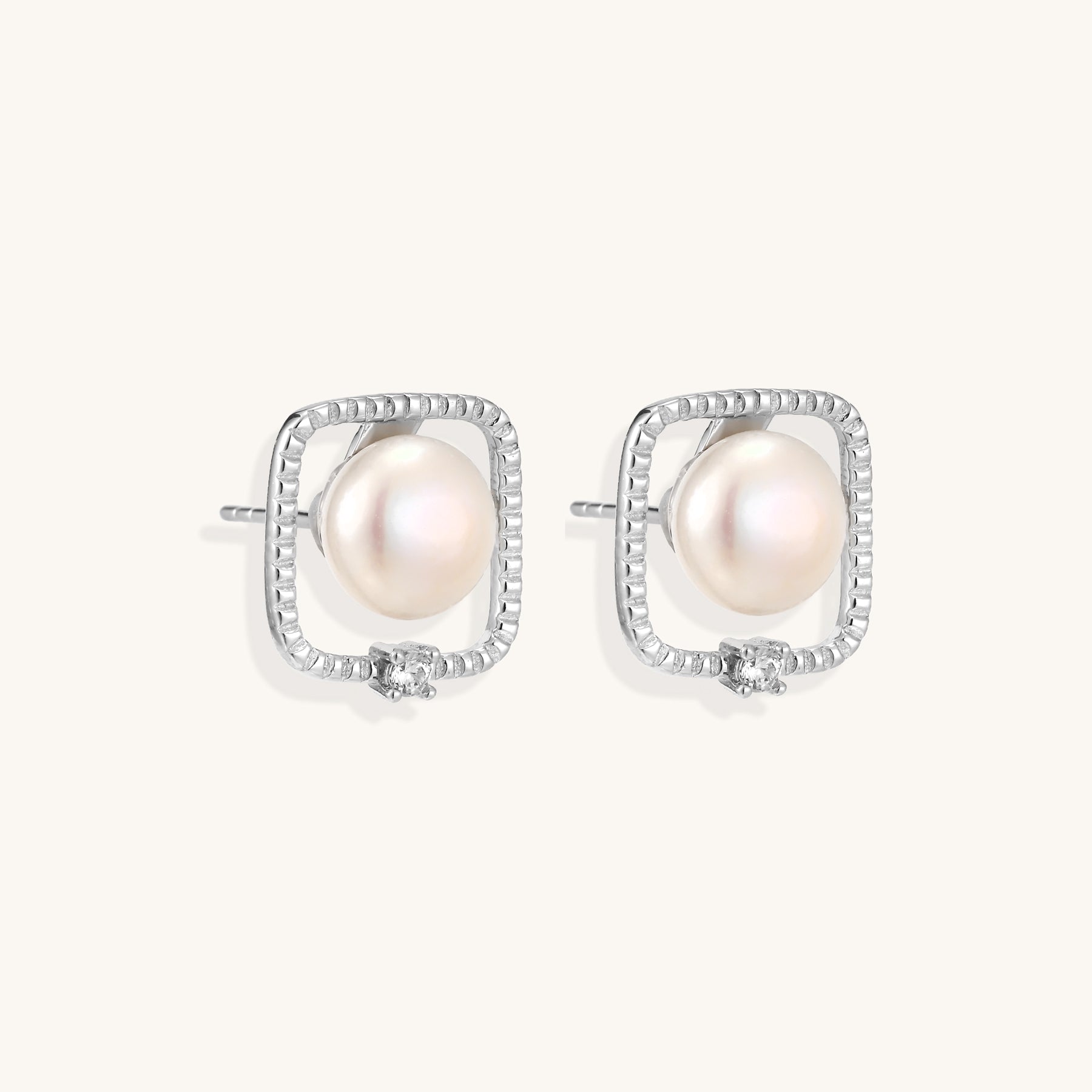 Square sterling silver stud earrings with freshwater pearls and crystal accents on white background.