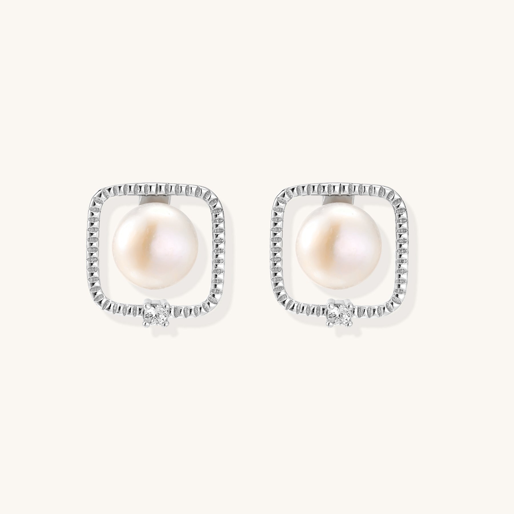 Square sterling silver stud earrings with freshwater pearls and crystal accents on white background.