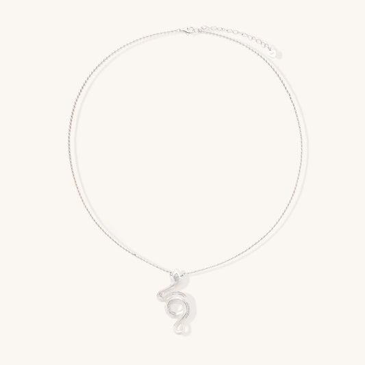 Sterling silver snake pendant necklace with zirconia crystals on adjustable chain against cream background