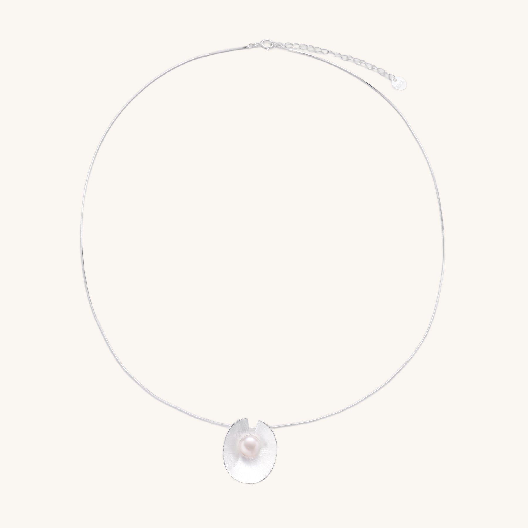 Delicate sterling silver necklace with oval iridescent pendant and central freshwater pearl on white background