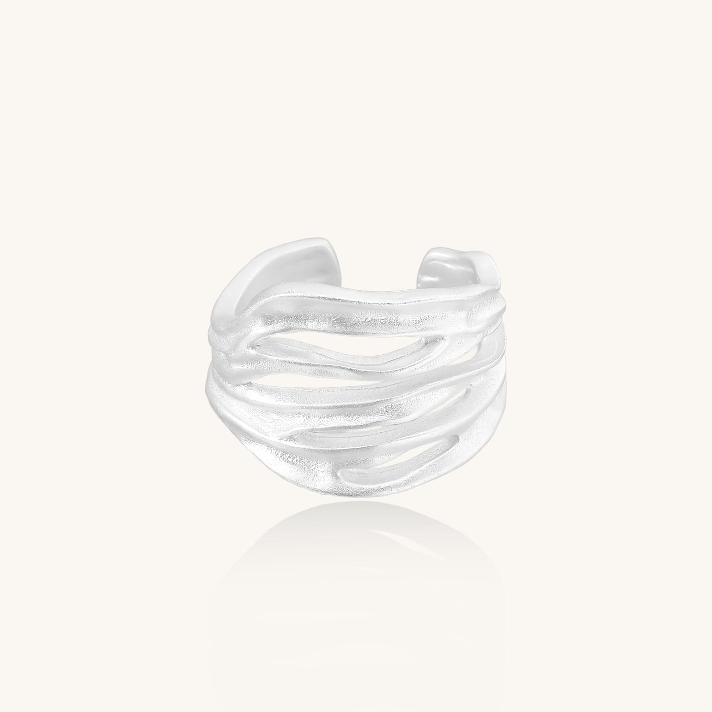 Wide sterling silver ring with flowing wave patterns and adjustable cuff design on white background.