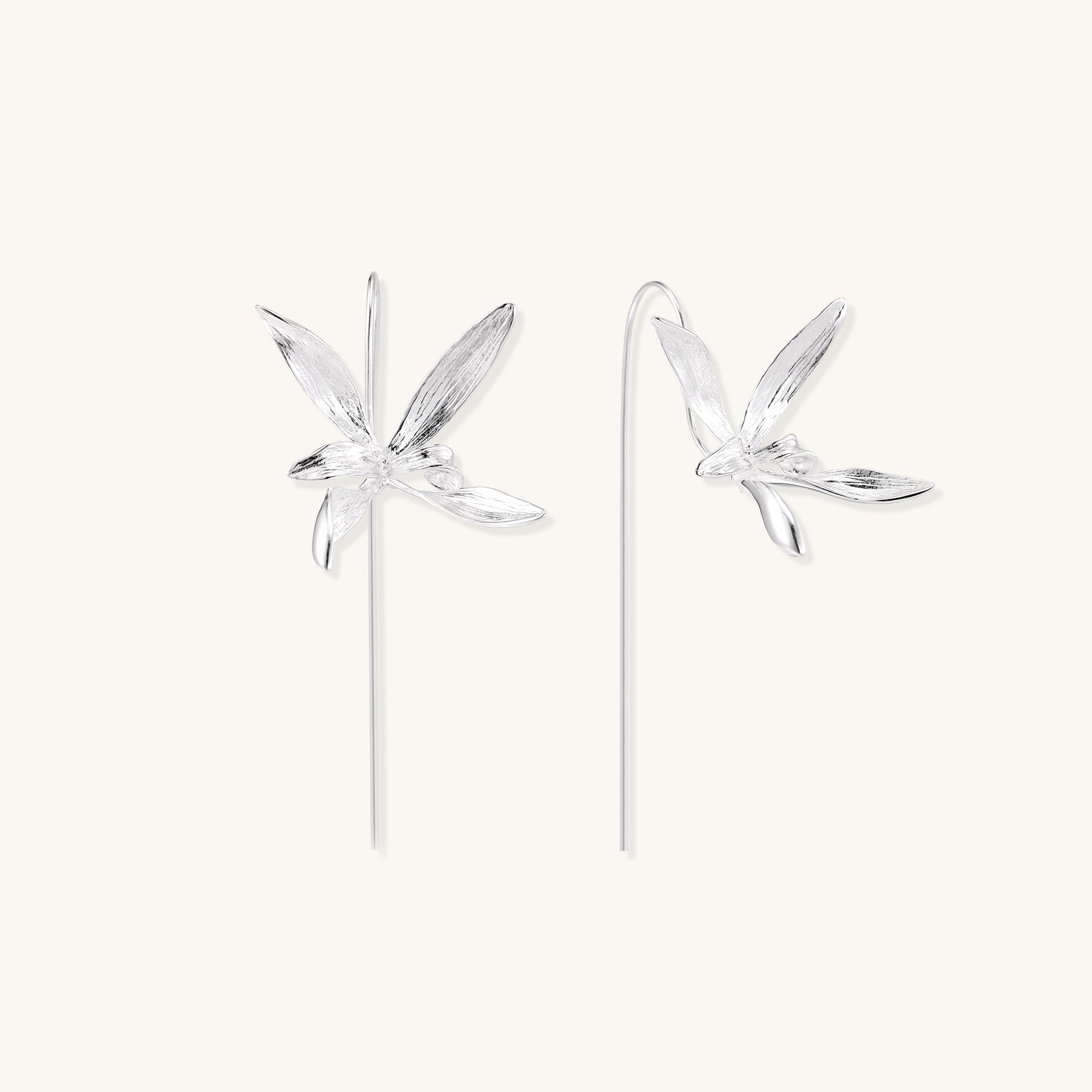 Delicate sterling silver flower earrings with long threader posts and five-petal design on white background.