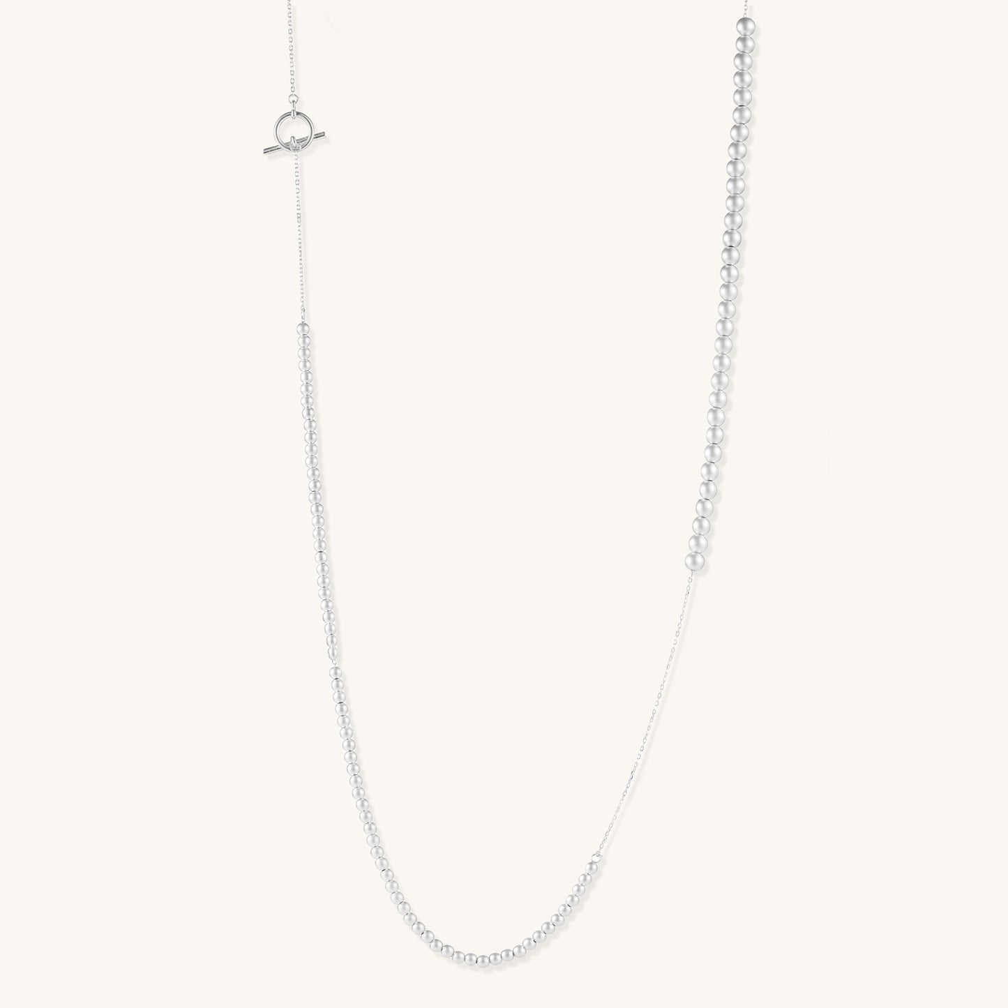 Sterling silver necklace with graduated pearl beads and delicate chain sections featuring a toggle clasp closure.