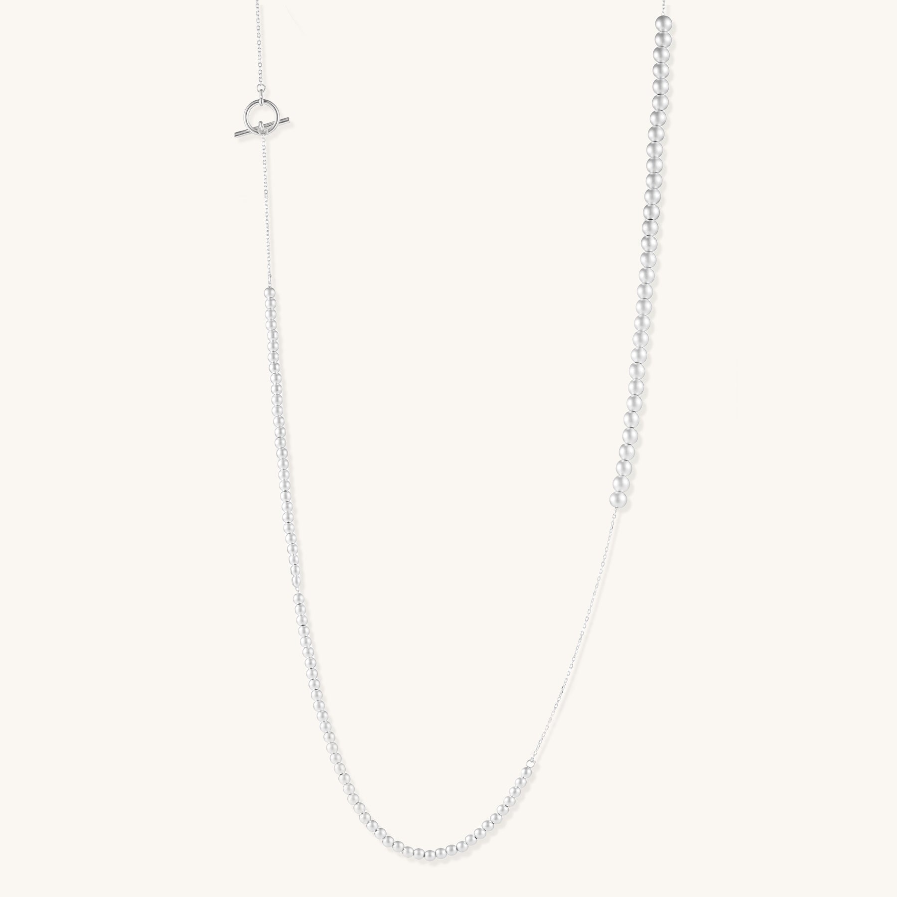 Sterling silver necklace with graduated pearl beads and delicate chain sections featuring a toggle clasp closure.