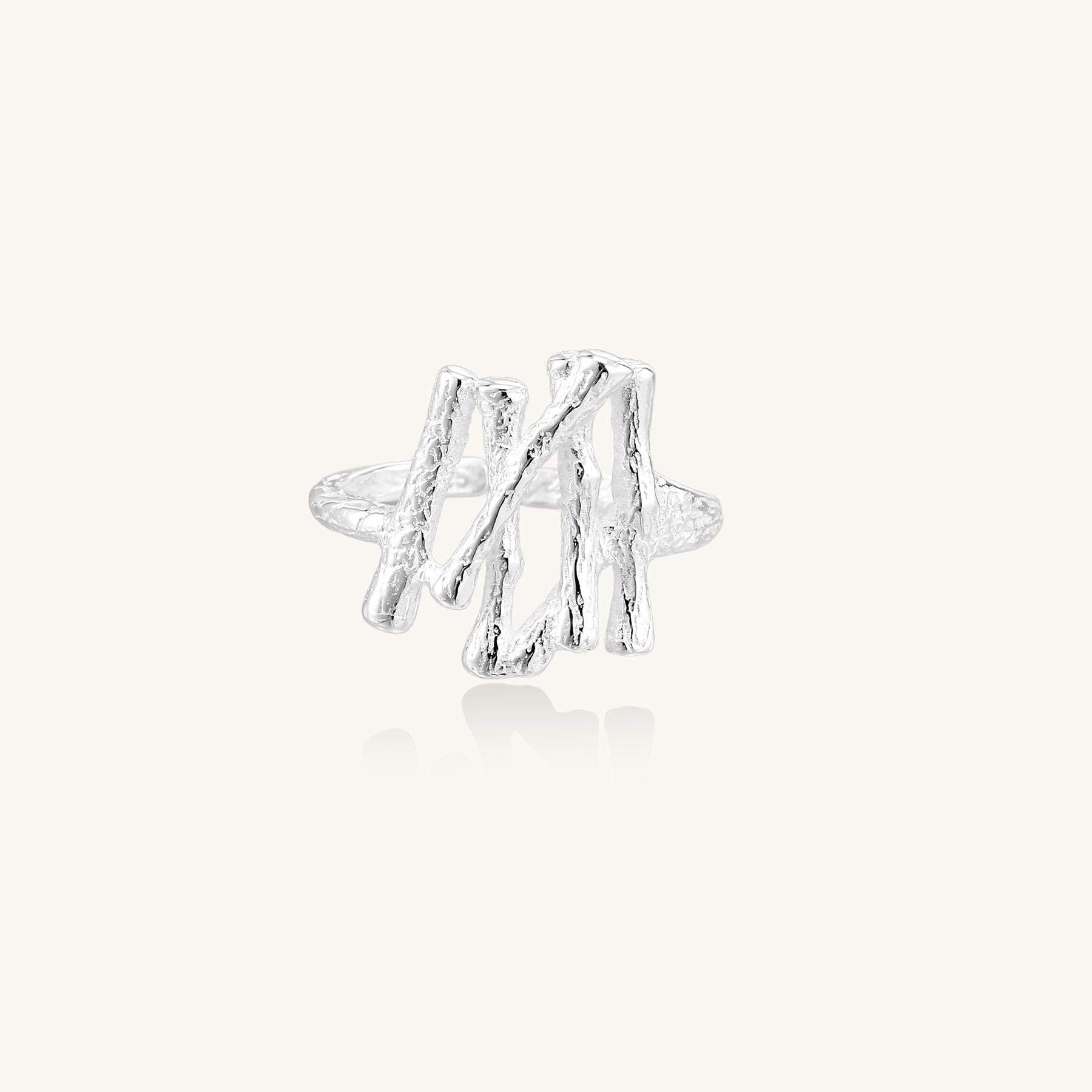 Chunky sterling silver ring with organic sculptural design and flowing abstract forms on white background