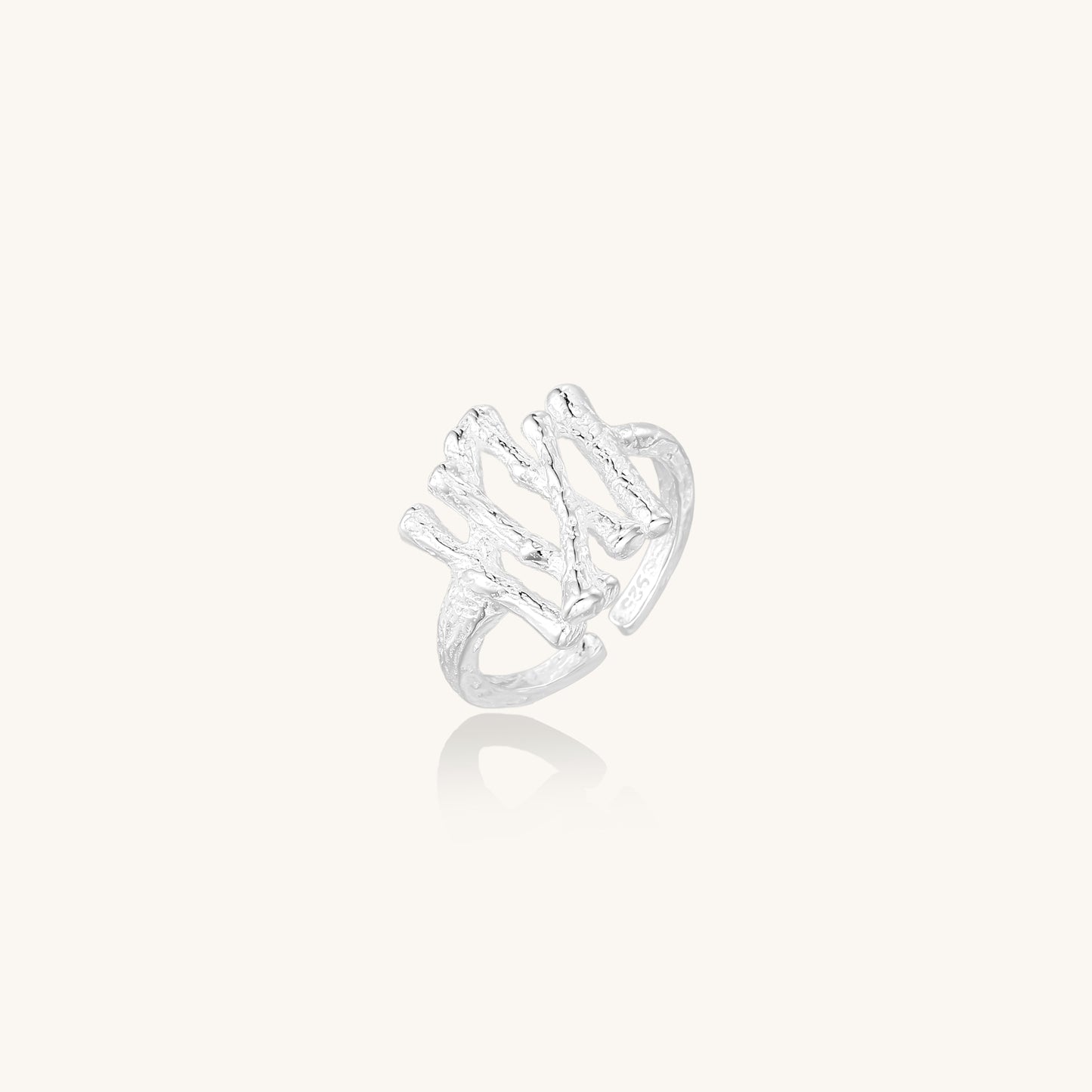 Chunky sterling silver ring with organic sculptural design and flowing abstract forms on white background