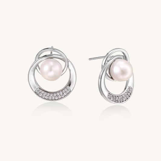 Gold-plated brass stud earrings with swirled circular design holding white freshwater pearls and small crystals