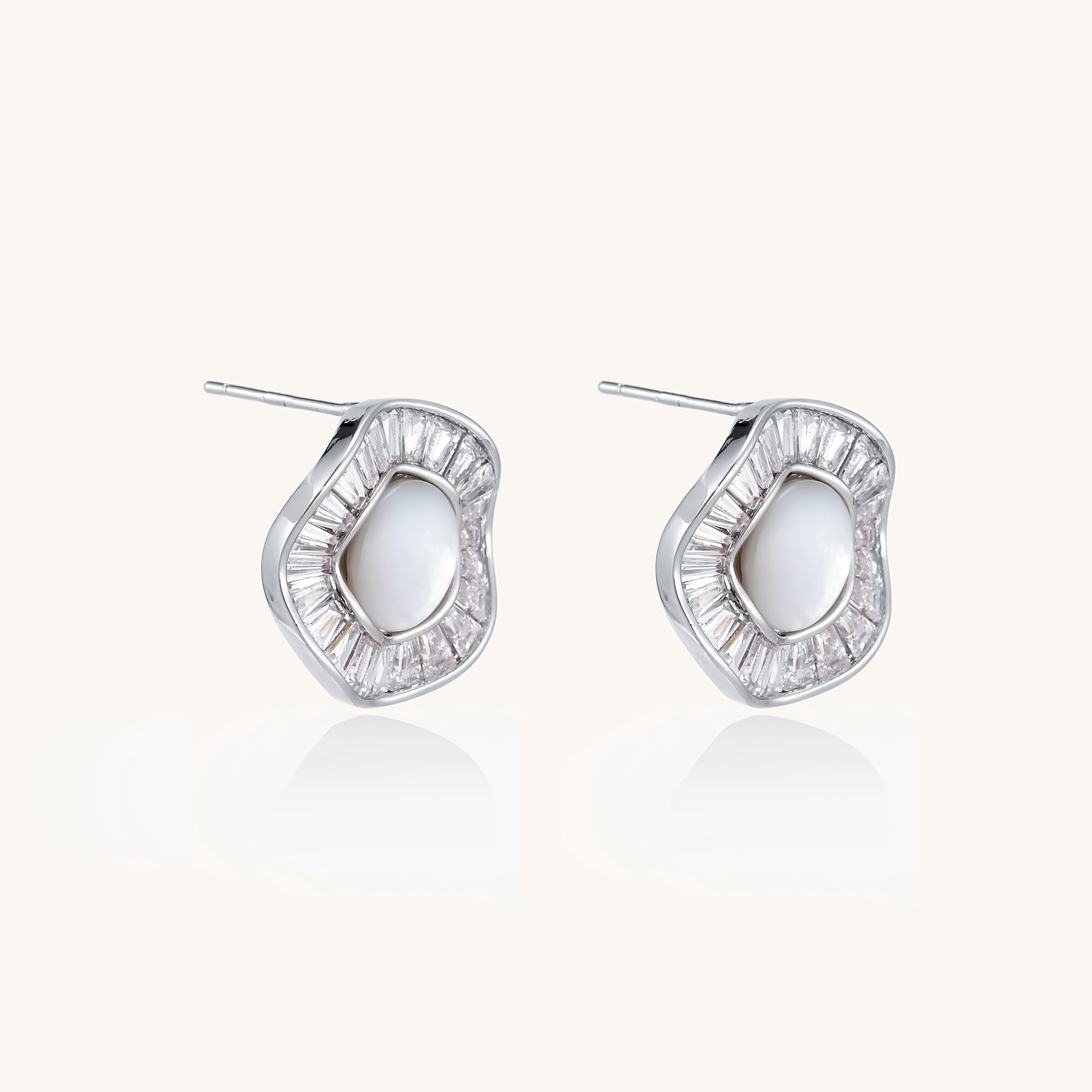 Gold-plated stud earrings with central freshwater pearl surrounded by baguette crystals in radial pattern