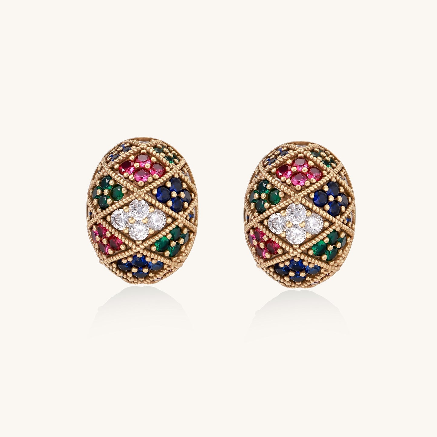 Oval gold-plated stud earrings with multicolor zirconia stones in geometric diamond pattern on white background.