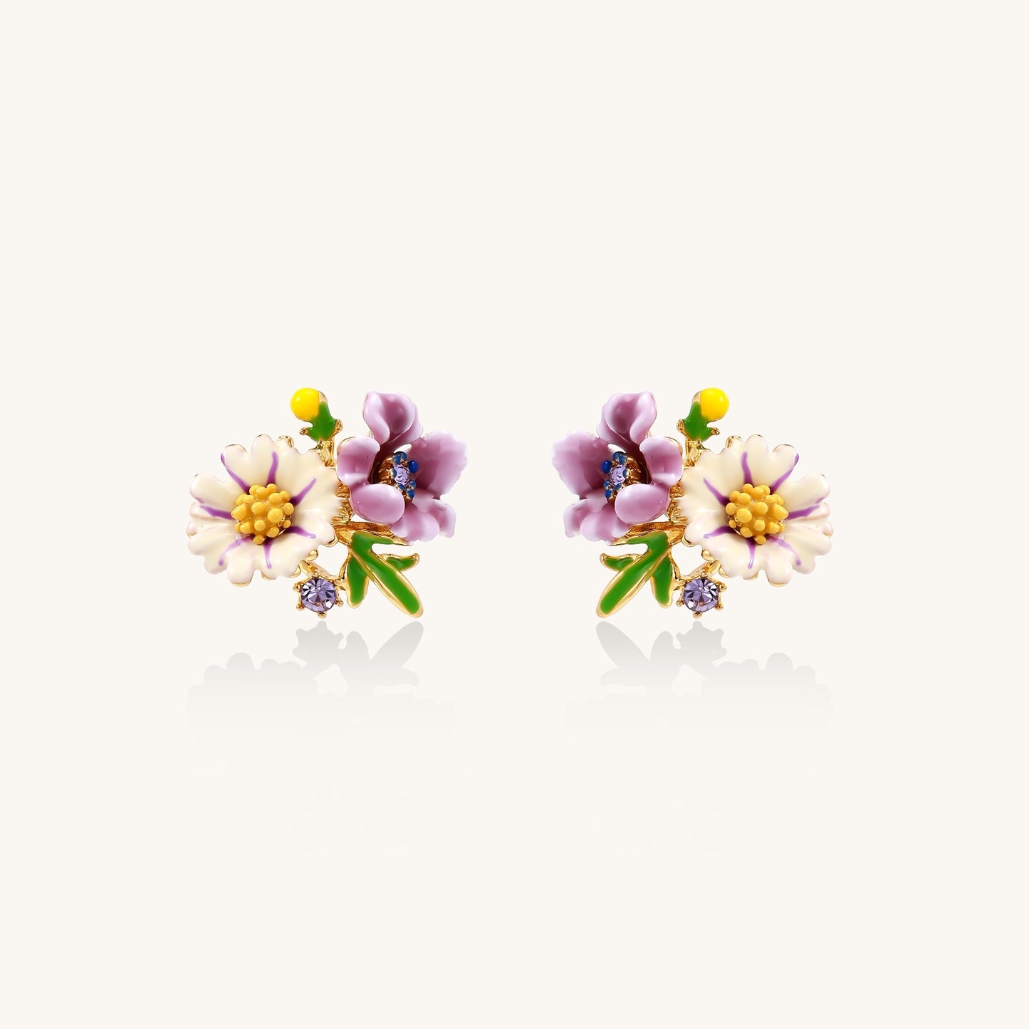 Delicate gold-plated stud earrings featuring white daisy and purple flowers with green leaves and crystal accents