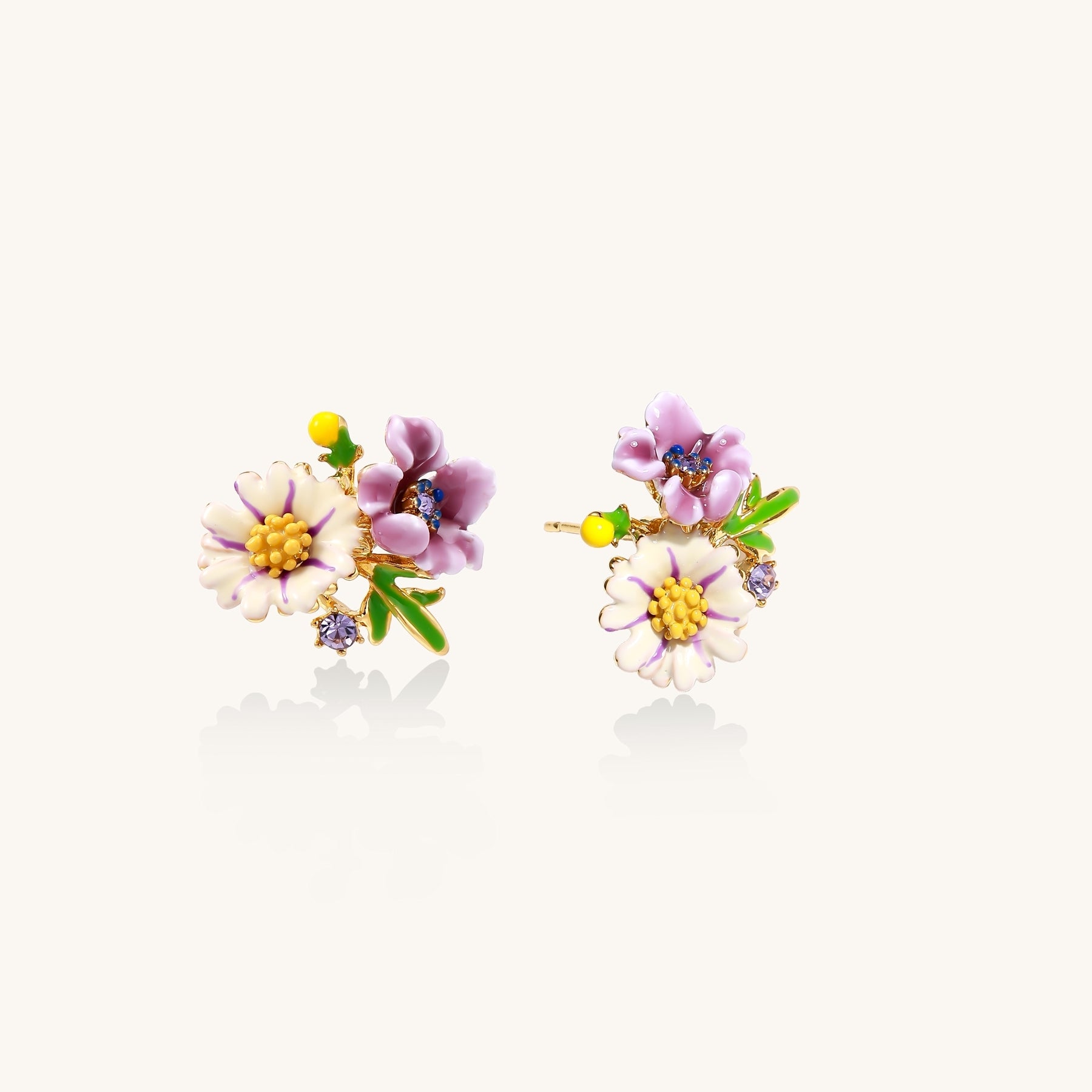 Delicate gold-plated stud earrings featuring white daisy and purple flowers with green leaves and crystal accents