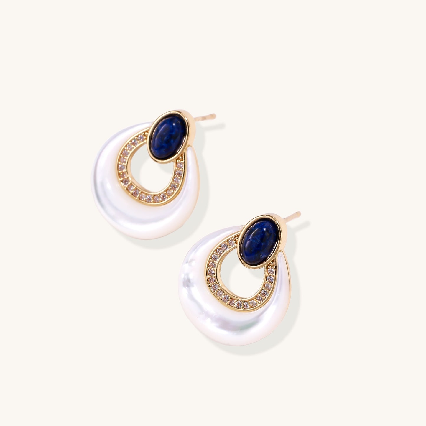 Gold-plated drop earrings featuring blue lapis lazuli ovals, diamond-studded circles, and iridescent mother of pearl teardrops