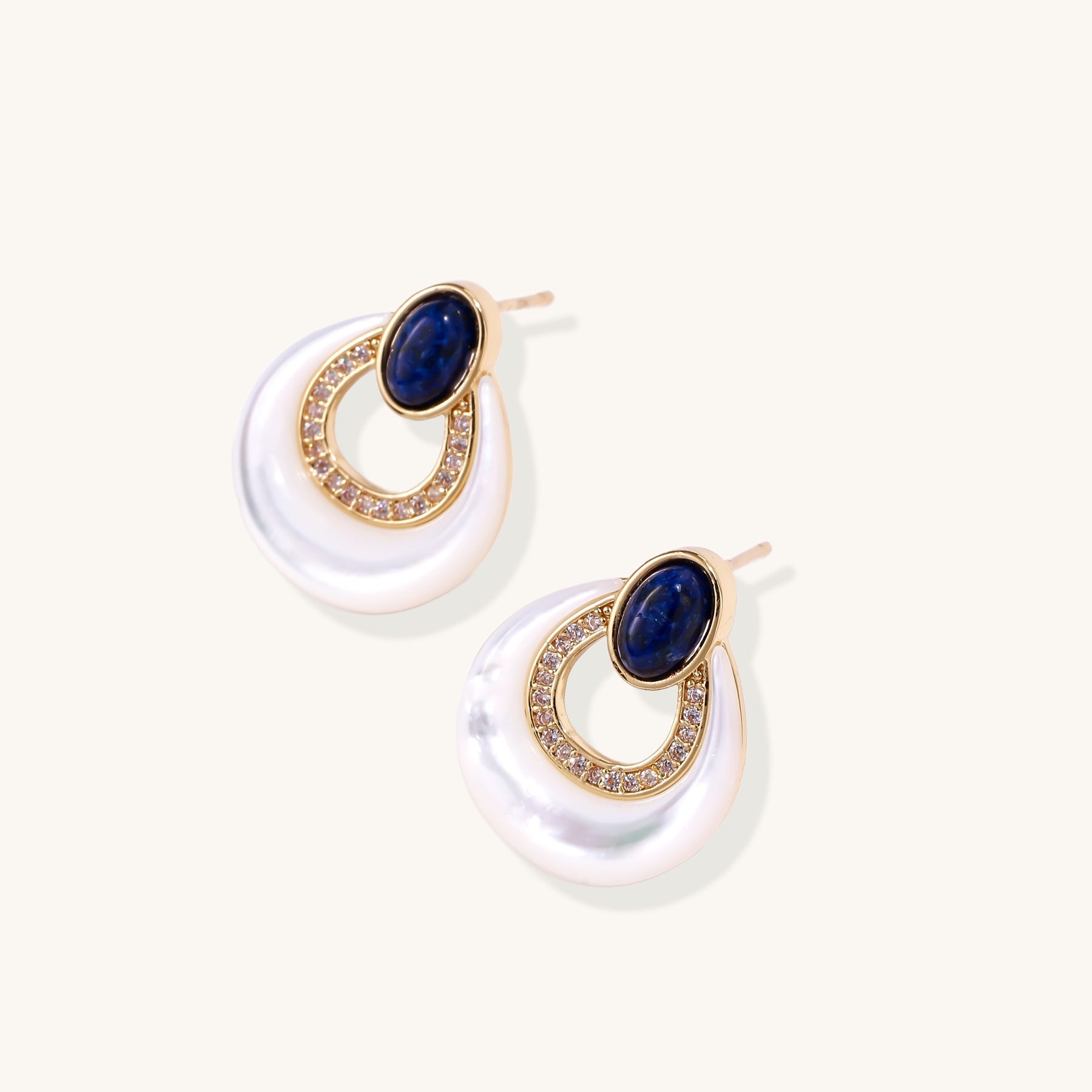 Gold-plated drop earrings featuring blue lapis lazuli ovals, diamond-studded circles, and iridescent mother of pearl teardrops
