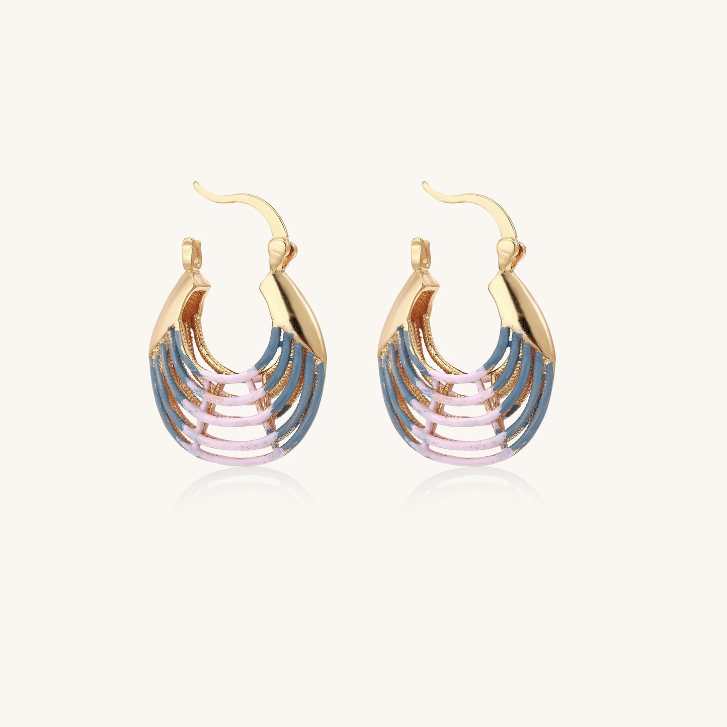 Gold hoop earrings with layered blue to pink enamel in shell pattern, photographed against white background