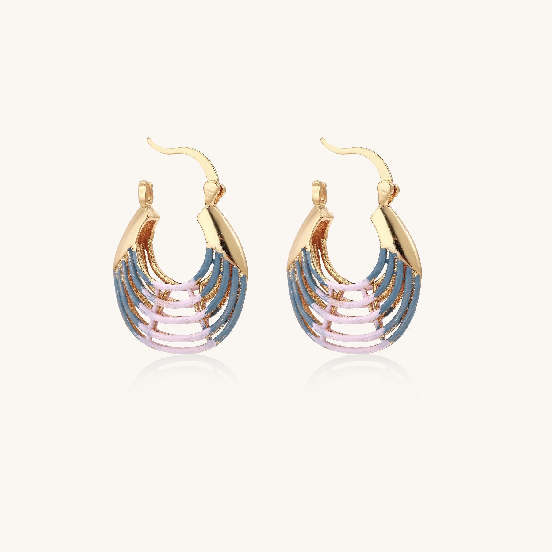 Gold hoop earrings with layered blue to pink enamel in shell pattern, photographed against white background