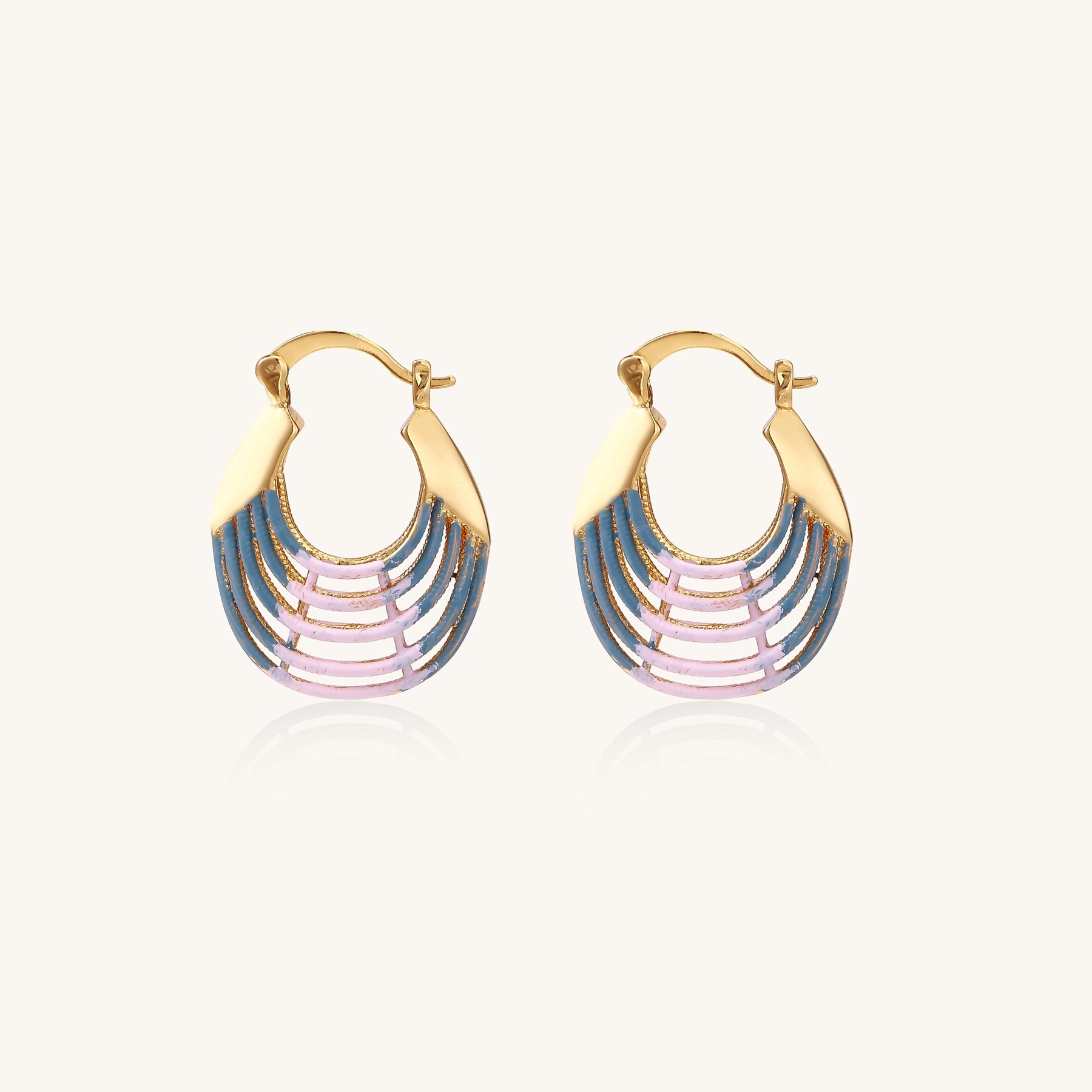 Gold hoop earrings with layered blue to pink enamel in shell pattern, photographed against white background
