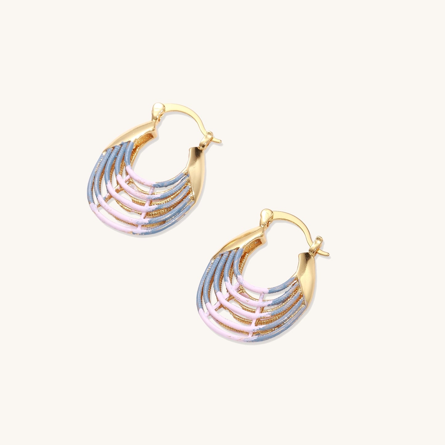 Gold hoop earrings with layered blue to pink enamel in shell pattern, photographed against white background