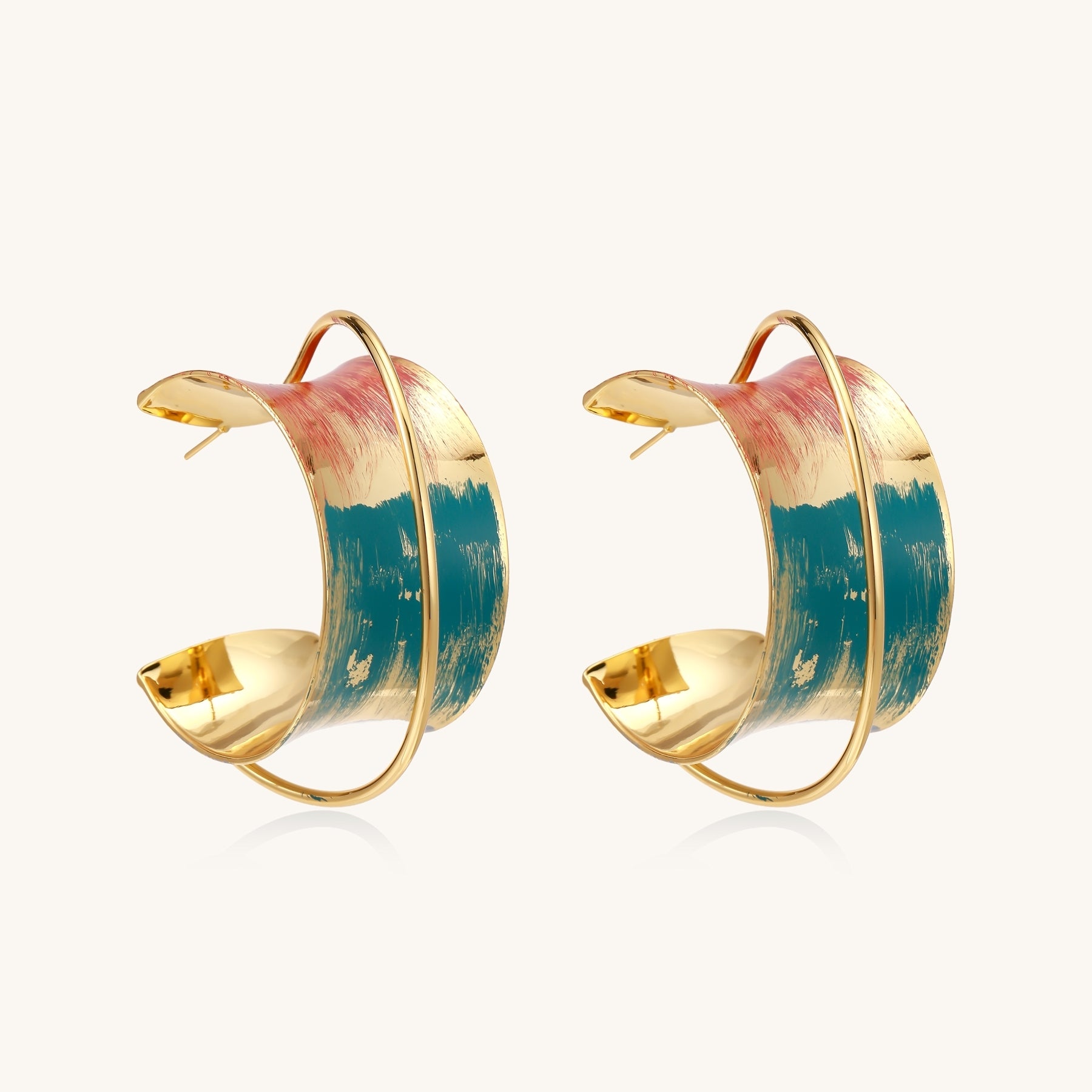 Gold-plated hoop earrings with colorful enamel brushstroke patterns in turquoise, coral, and gold tones