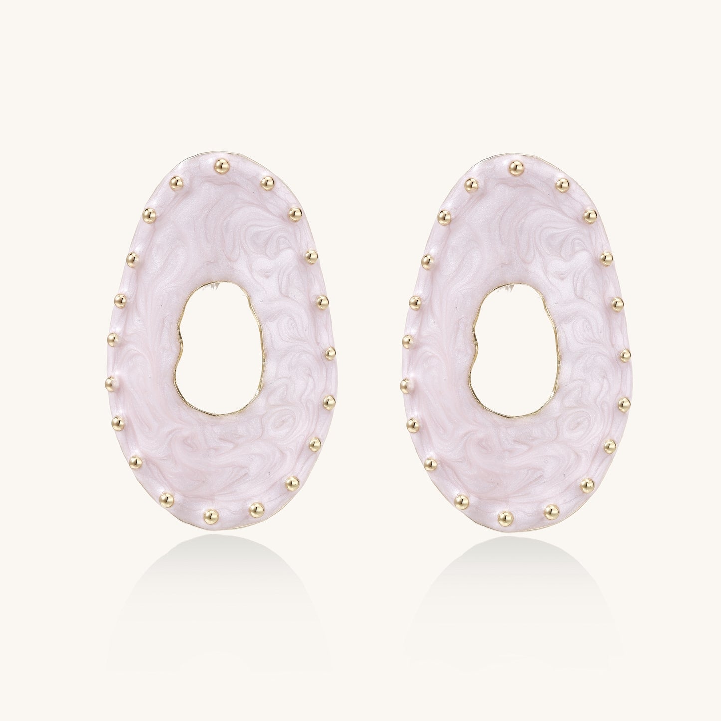 Oval lavender enamel earrings with gold studs around perimeter and cutout centers on white background