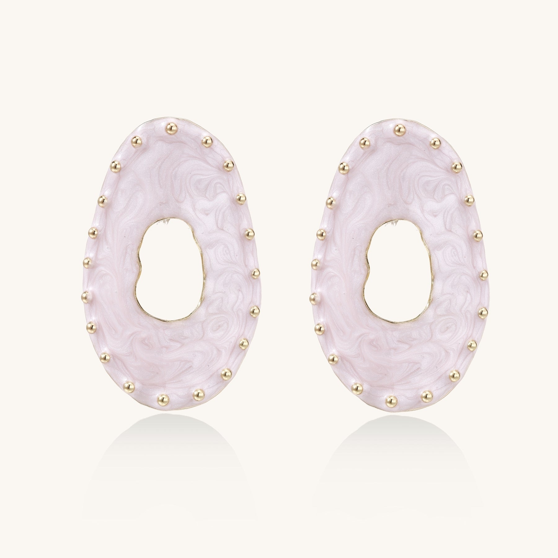 Oval lavender enamel earrings with gold studs around perimeter and cutout centers on white background