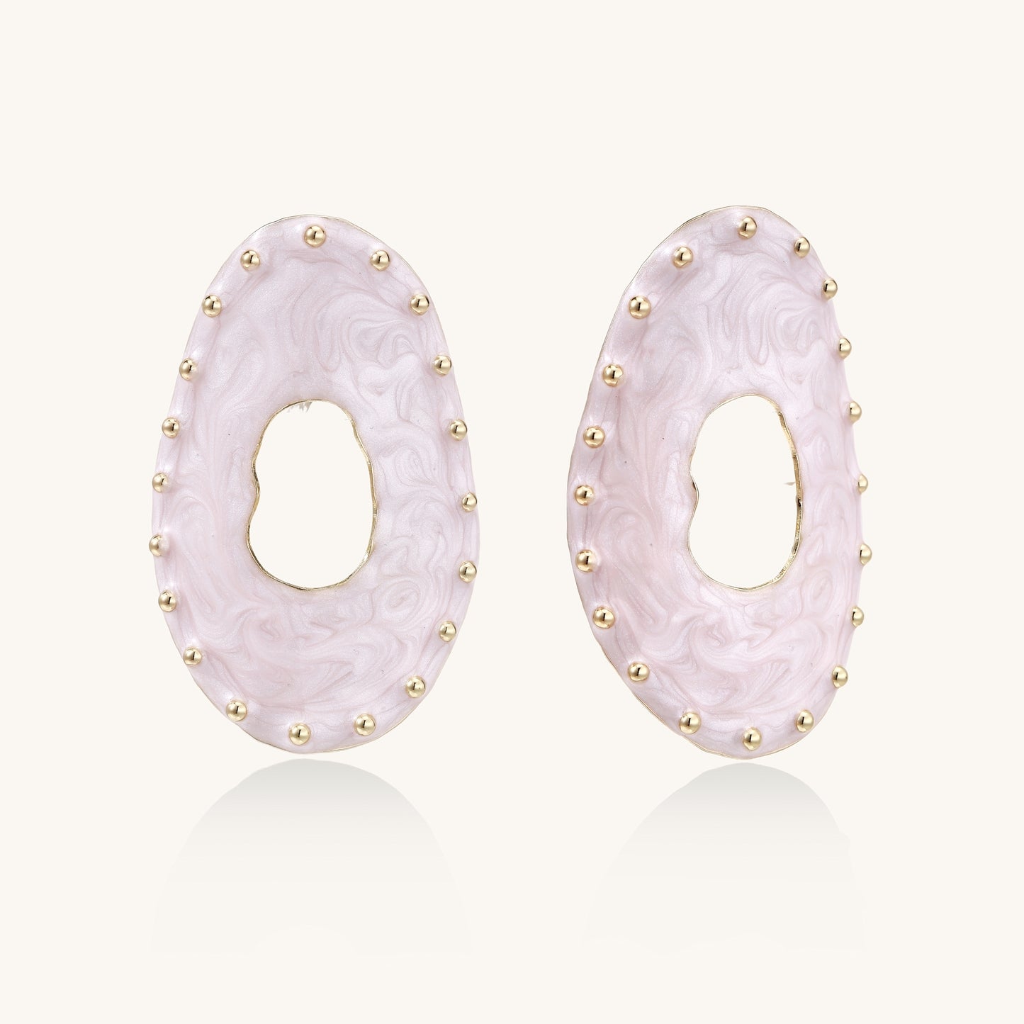 Oval lavender enamel earrings with gold studs around perimeter and cutout centers on white background