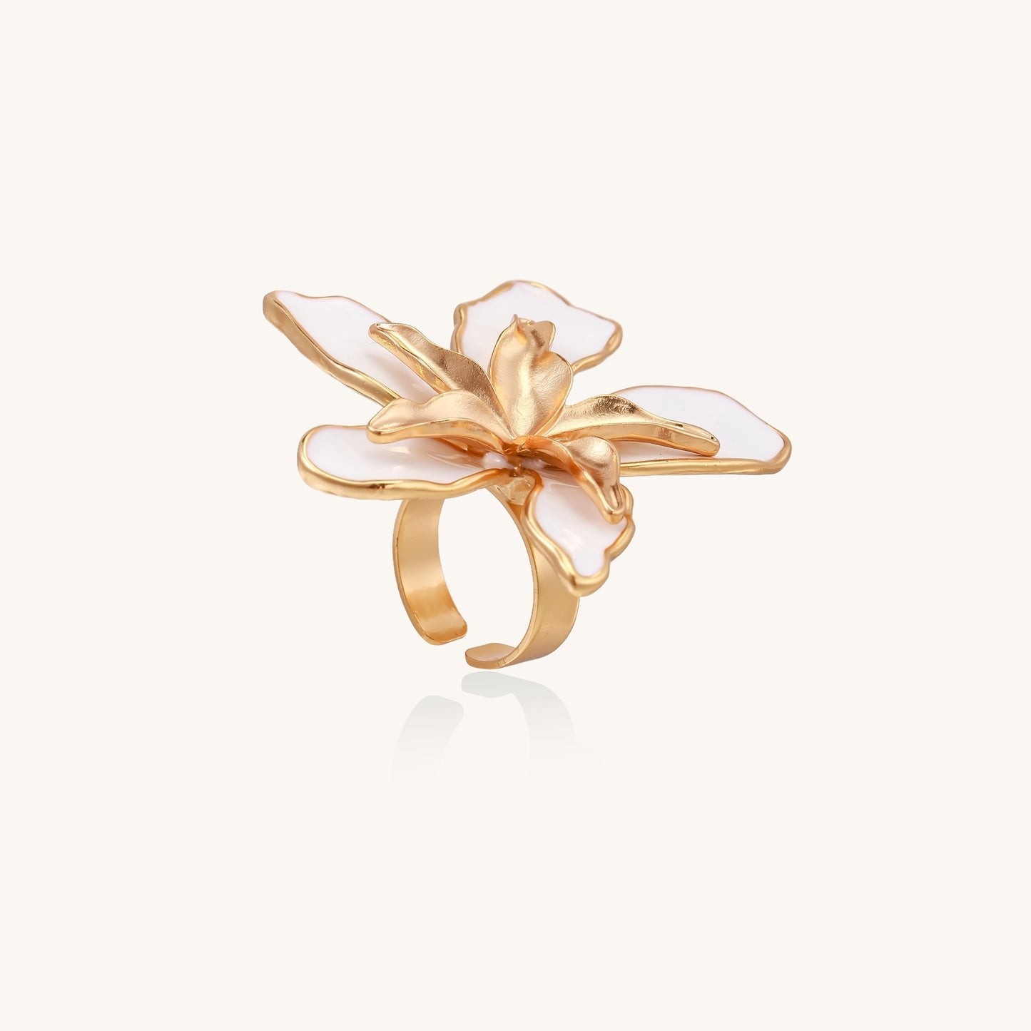 Gold-plated adjustable ring with large white enamel flower design featuring smooth petals outlined in gold