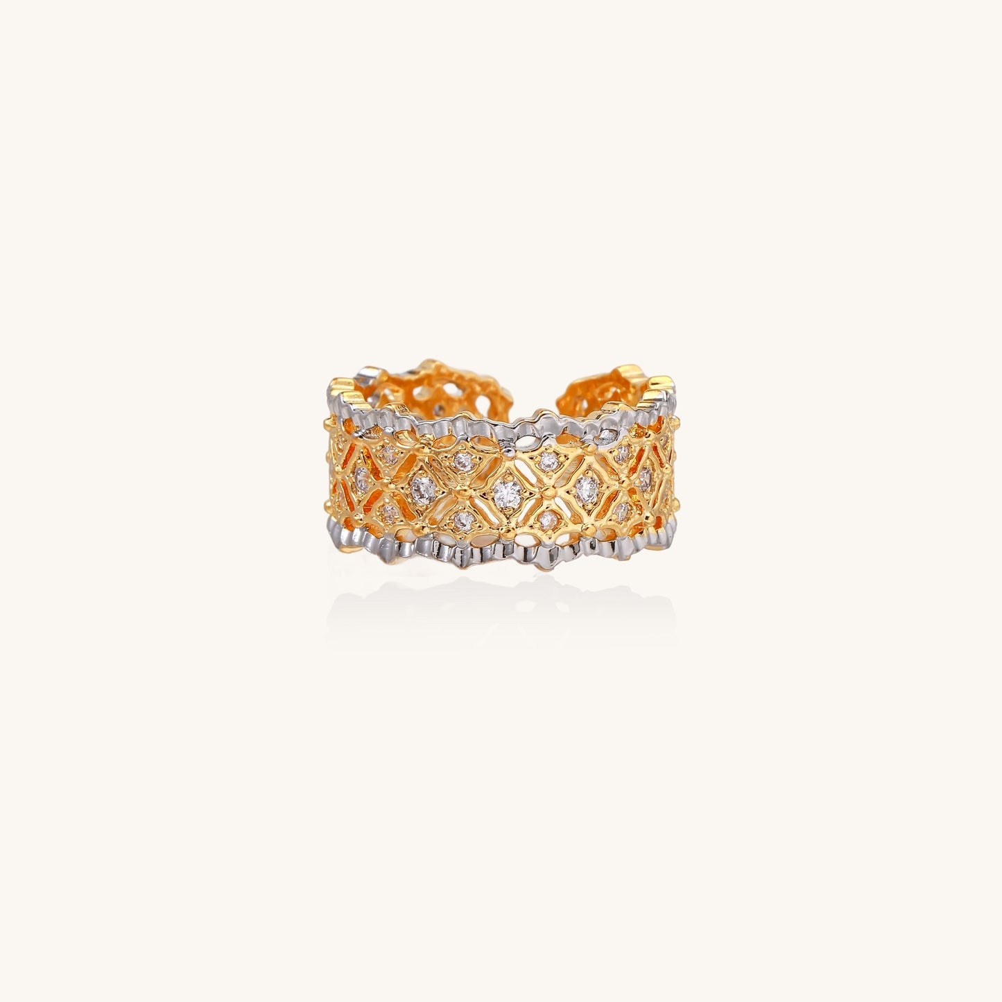 Bold geometric ring with lattice pattern in gold-plated brass featuring multiple tiers of sparkling zirconia stones
