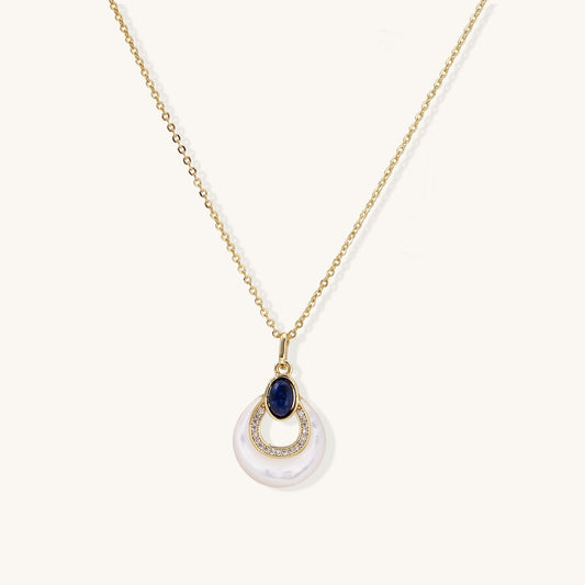 Layered pendant necklace with deep blue lapis lazuli stone, crystals, and white mother of pearl on 18k gold plated chain