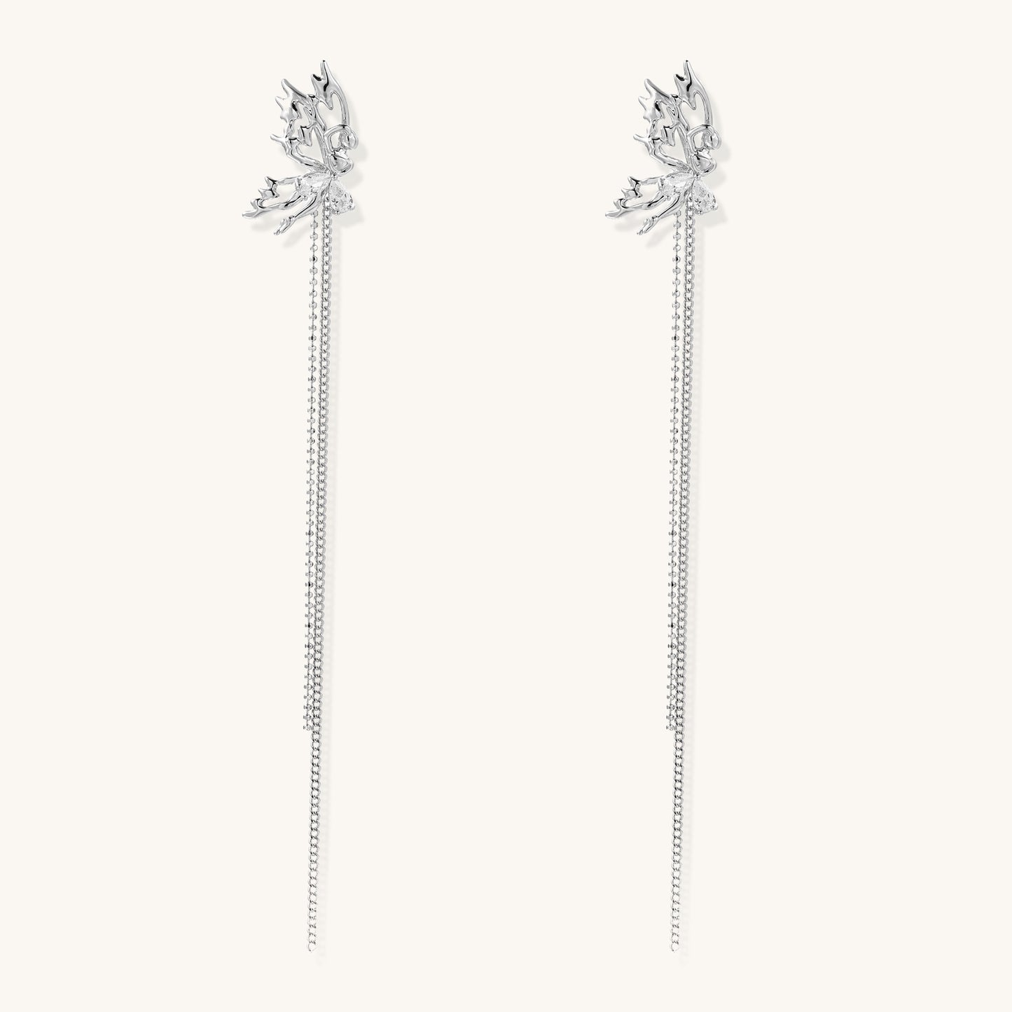 Long gold-plated earrings with star motifs and delicate chain tassels cascading down, featuring zirconia accents.