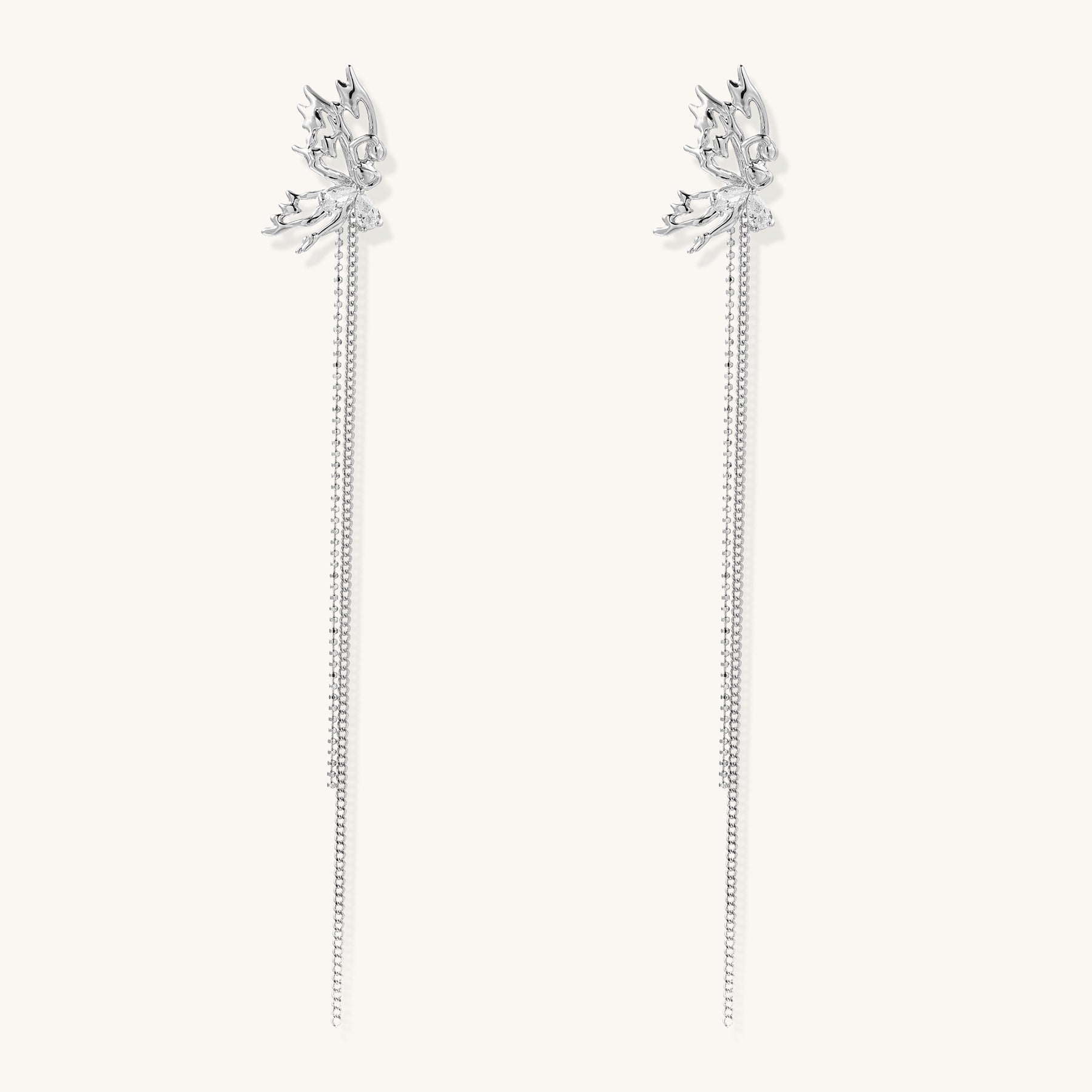 Long gold-plated earrings with star motifs and delicate chain tassels cascading down, featuring zirconia accents.
