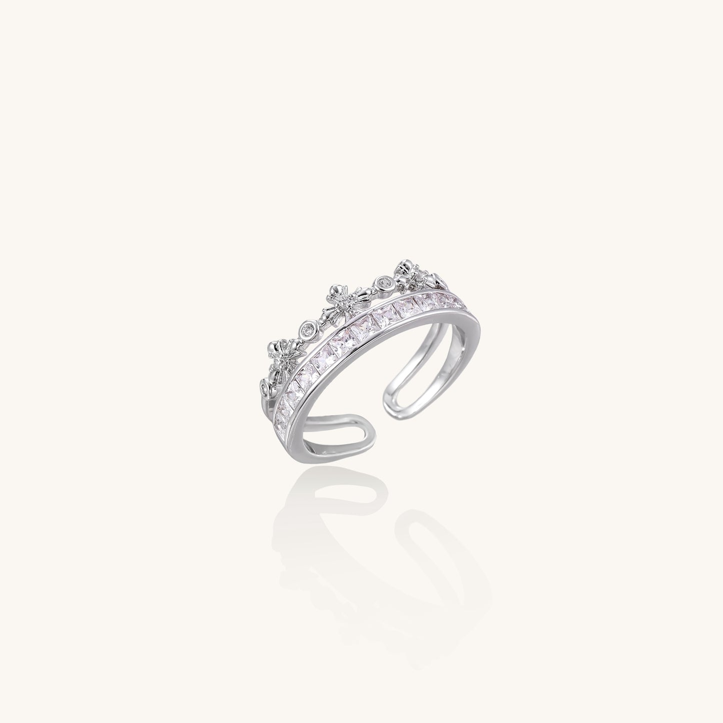 Adjustable gold-plated crown ring with zirconia crystals in ornate tiara design on white background.