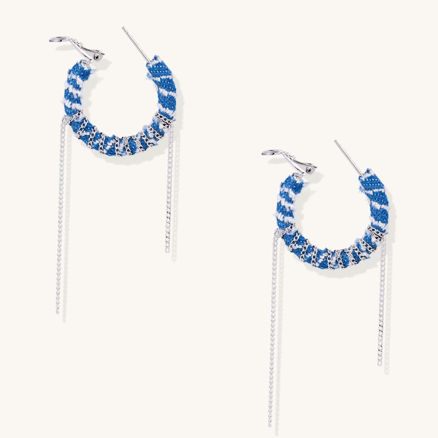 Blue and white checkered denim-wrapped hoop earrings with delicate silver chain dangles on neutral background