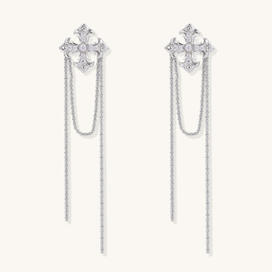 Ornate gold-plated cross earrings with zirconia crystals and flowing chain details on white background