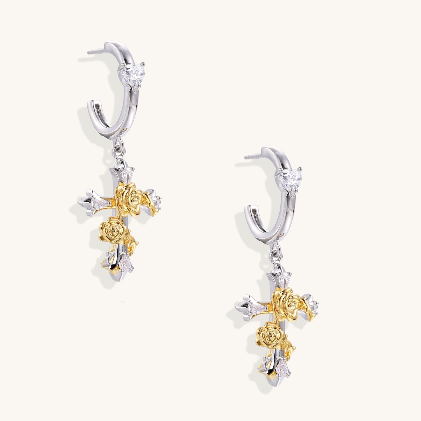 Ornate cross-shaped dangle earrings with gold roses and sparkling zirconia stars on silver-toned base with hoop closures.